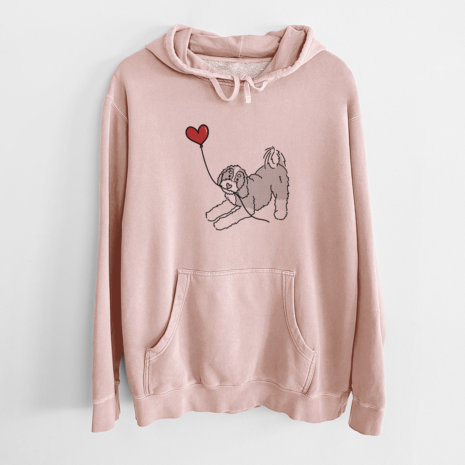 Minimalist line drawing of a Bernedoodle Heart String holding a heart balloon on a Dusty Pink Unisex pigment dyed hoodie