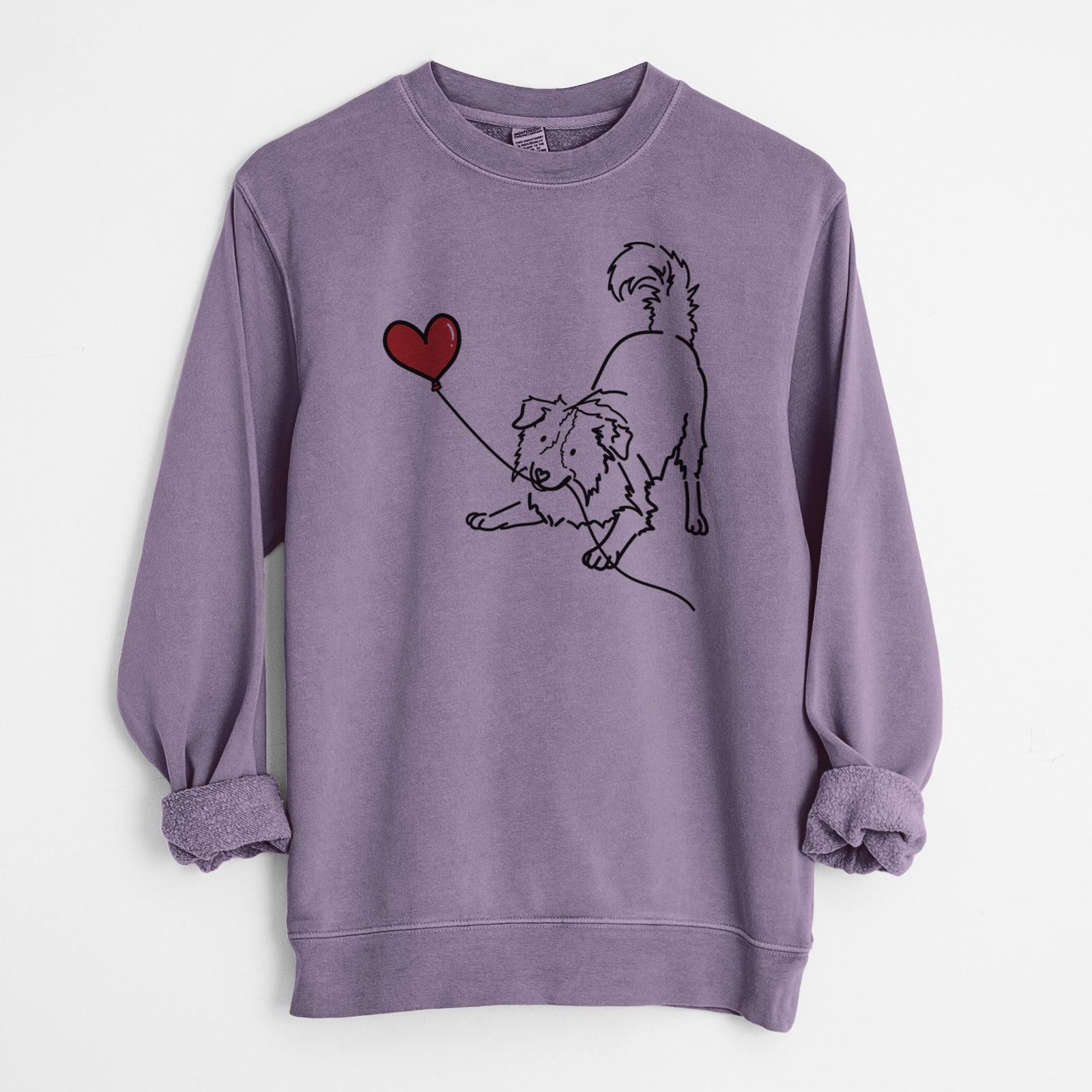 Minimalist line drawing of a Border Collie Heart String holding a heart balloon on a Plum Unisex pigment dyed crew sweatshirt