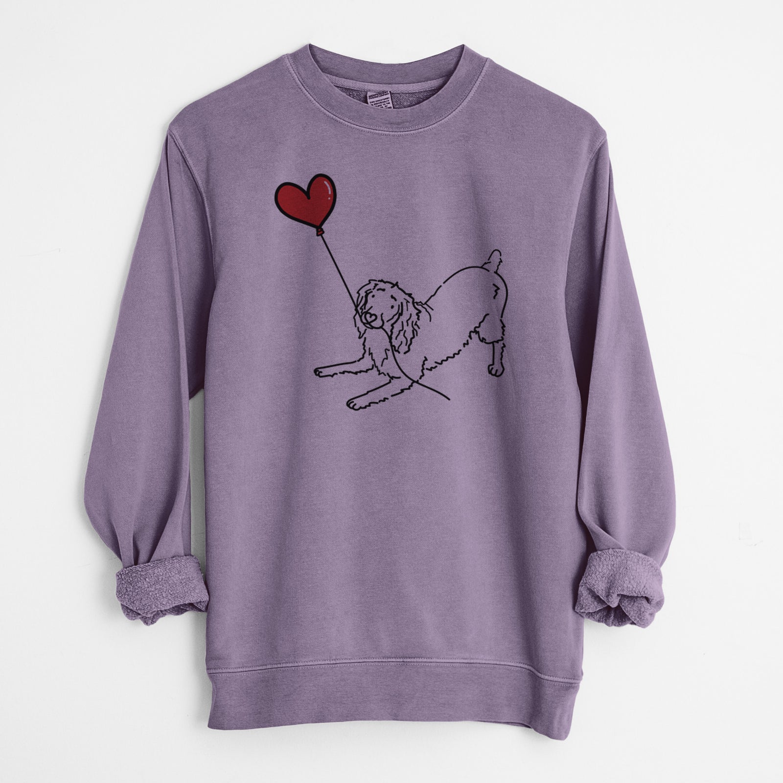 Minimalist line drawing of a Boykin Spaniel Heart String holding a heart balloon on a Plum Unisex pigment dyed crew sweatshirt