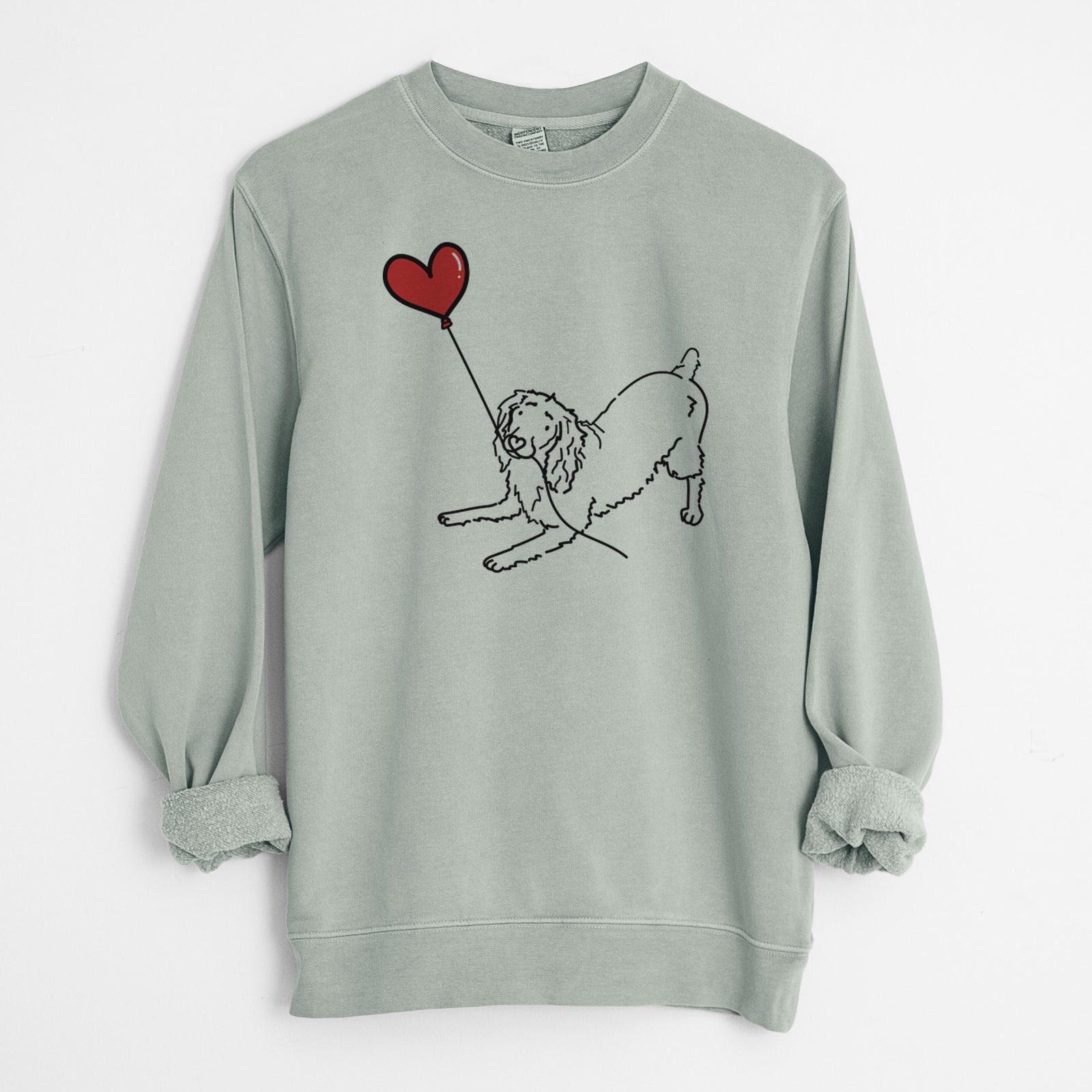 Minimalist line drawing of a Boykin Spaniel Heart String holding a heart balloon on a Sage Unisex pigment dyed crew sweatshirt