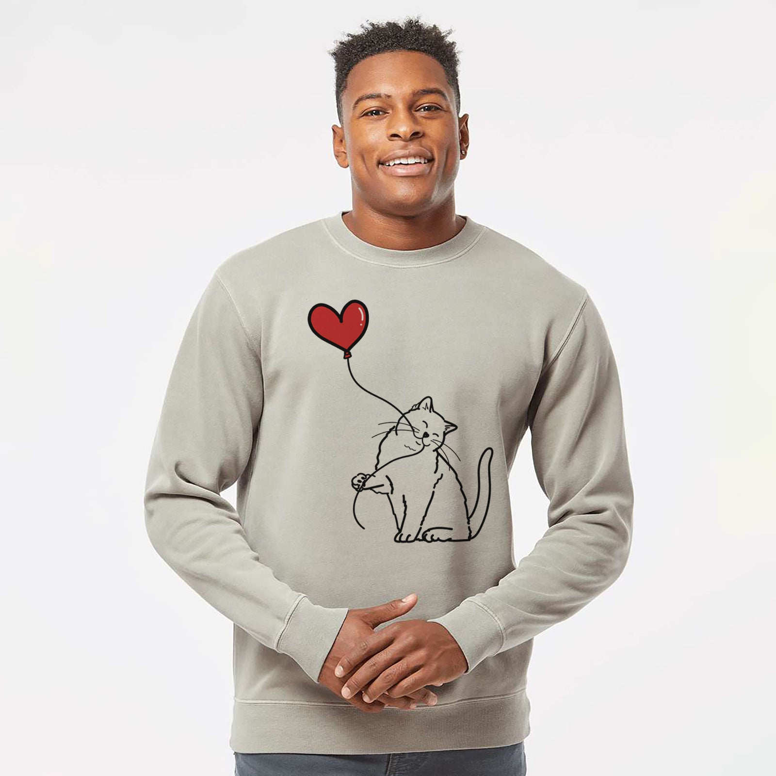Minimalist line drawing of a British Shorthair Cat Heart String holding a heart balloon on a Cement Unisex pigment dyed crew sweatshirt