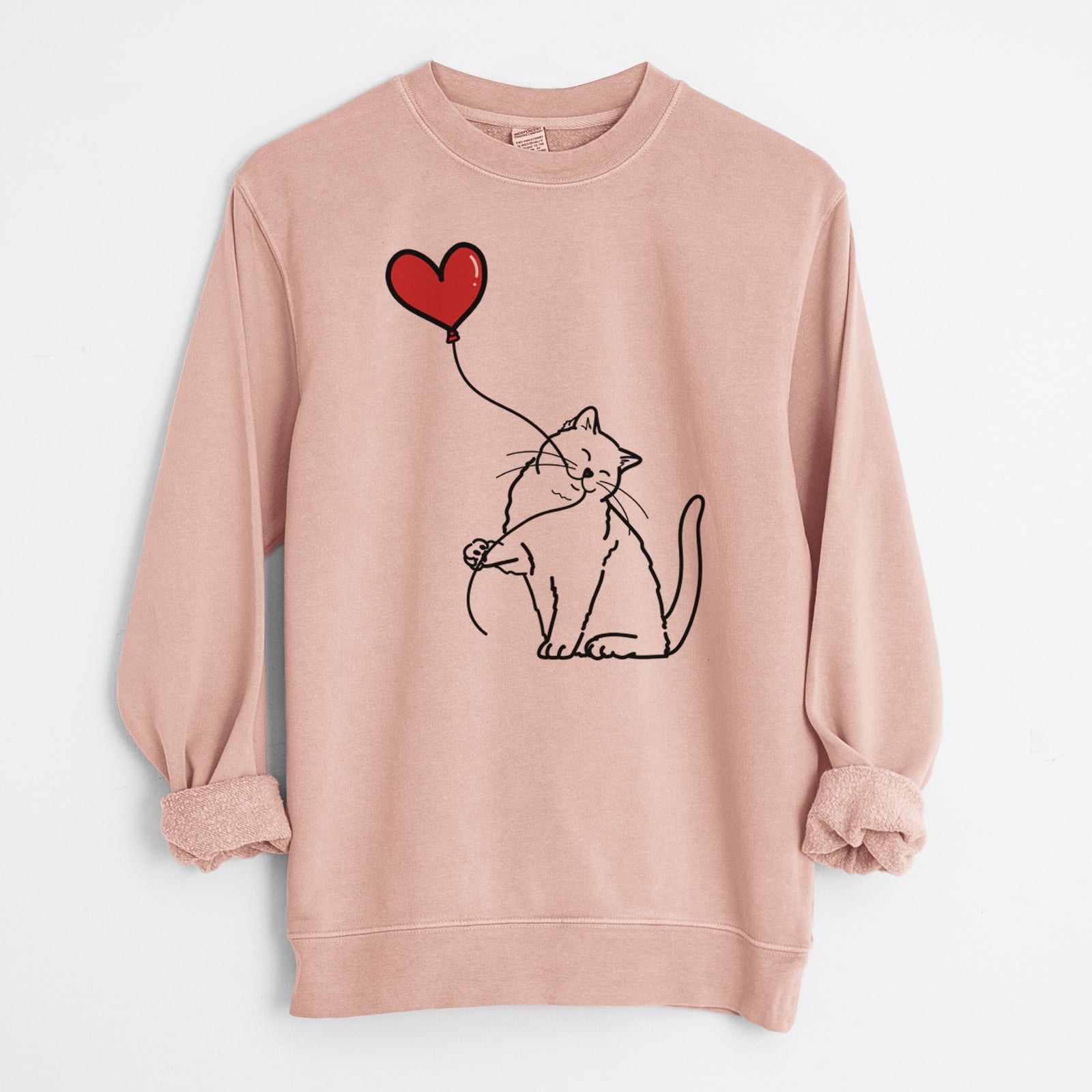 Minimalist line drawing of a British Shorthair Cat Heart String holding a heart balloon on a Dusty Pink Unisex pigment dyed crew sweatshirt