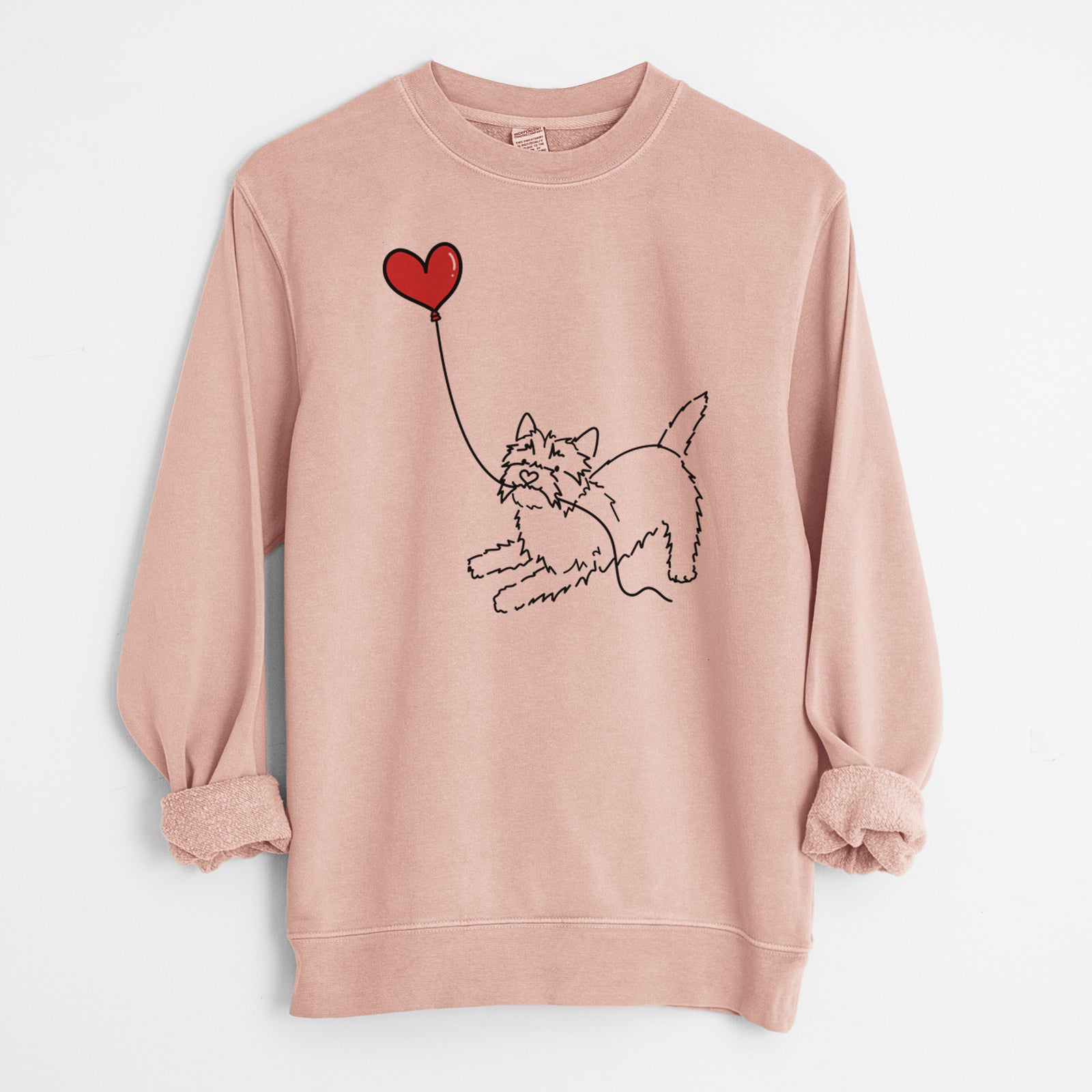 Minimalist line drawing of a Cairn Terrier Heart String holding a heart balloon on a Dusty Pink Unisex pigment dyed crew sweatshirt