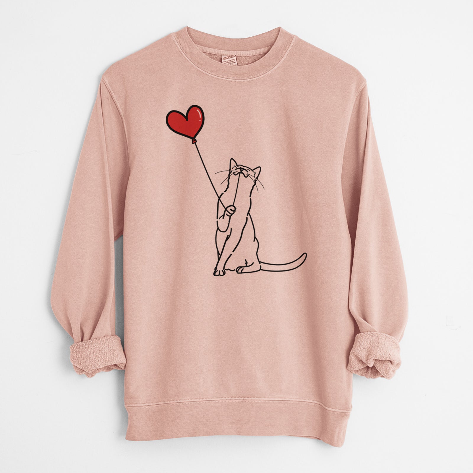 Minimalist line drawing of a Cat Heart String holding a heart balloon on a Dusty Pink Unisex pigment dyed crew sweatshirt