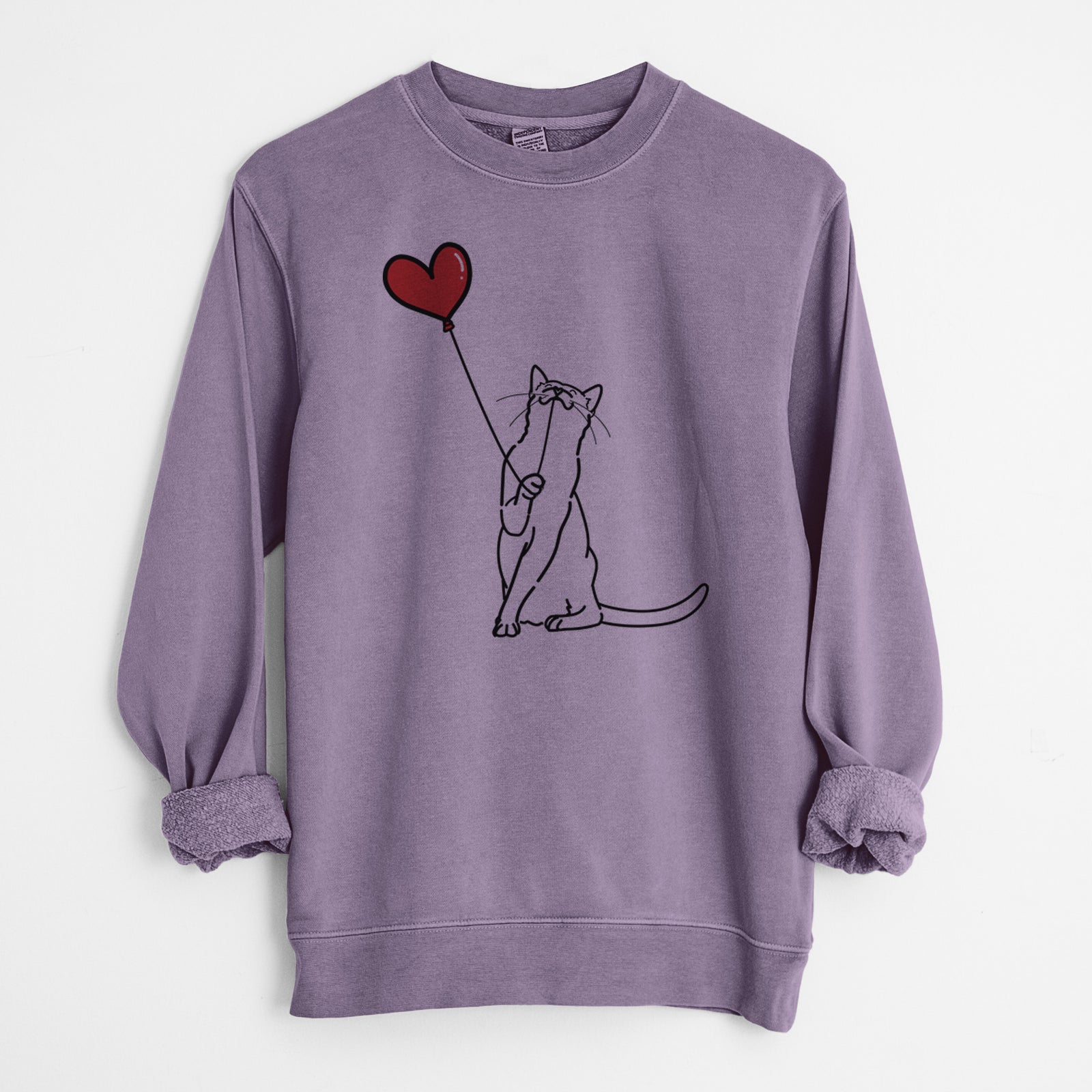 Minimalist line drawing of a Cat Heart String holding a heart balloon on a Plum Unisex pigment dyed crew sweatshirt