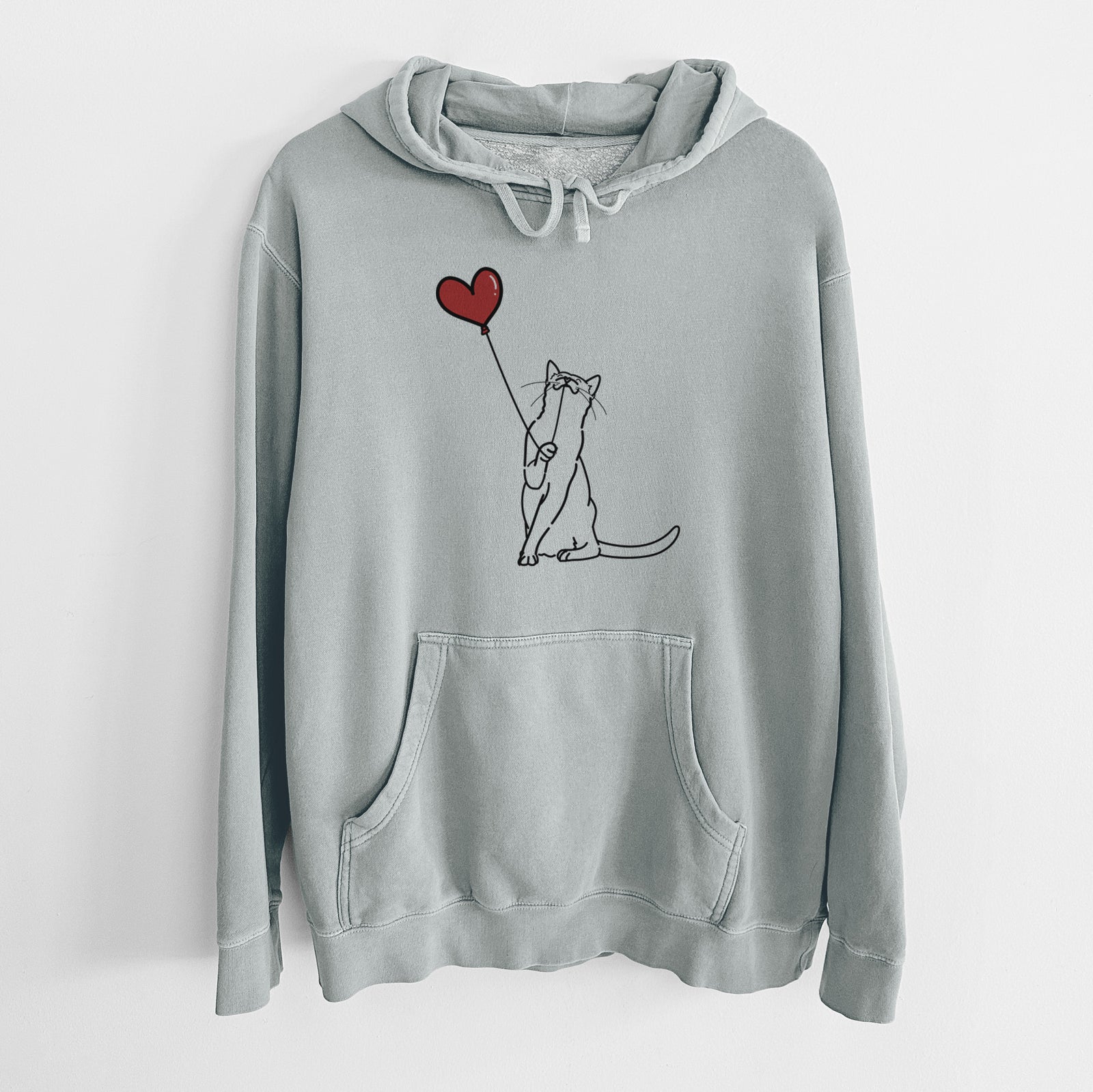 Minimalist line drawing of a Cat Heart String holding a heart balloon on a Sage Unisex pigment dyed hoodie