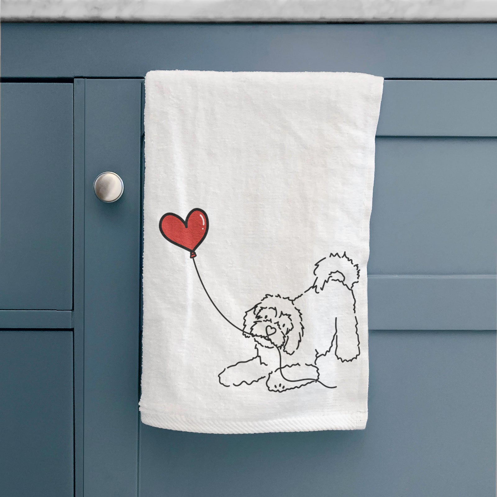Minimalist line drawing of a Cavachon Heart String holding a heart balloon on a decorative hand towel