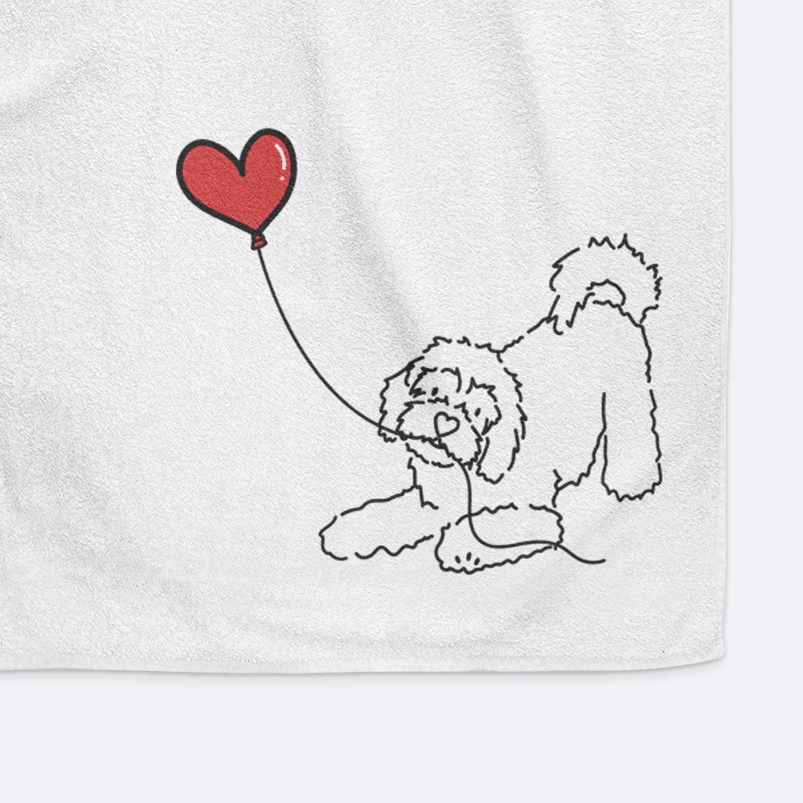 Minimalist line drawing of a Cavachon Heart String holding a heart balloon on a decorative hand towel