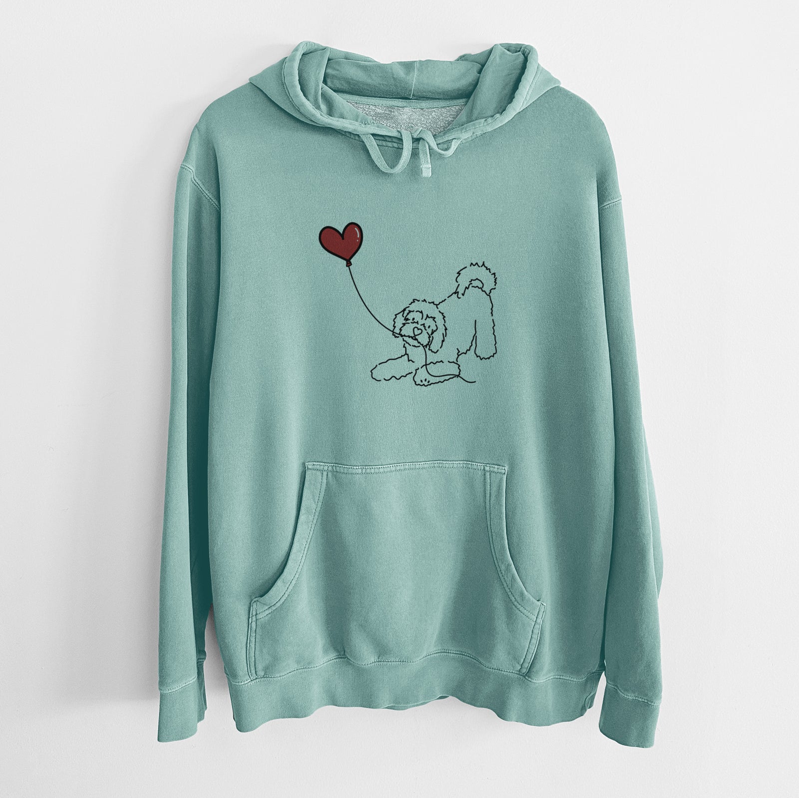 Minimalist line drawing of a Cavachon Heart String holding a heart balloon on a Mint Unisex pigment dyed hoodie