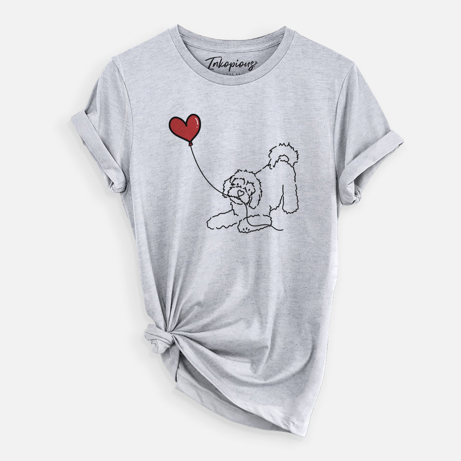 Minimalist line drawing of a Cavachon Heart String holding a heart balloon on a Grey Unisex crewneck