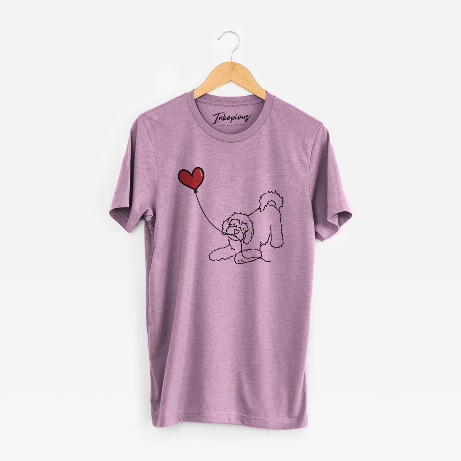 Minimalist line drawing of a Cavachon Heart String holding a heart balloon on an Orchid Unisex crewneck