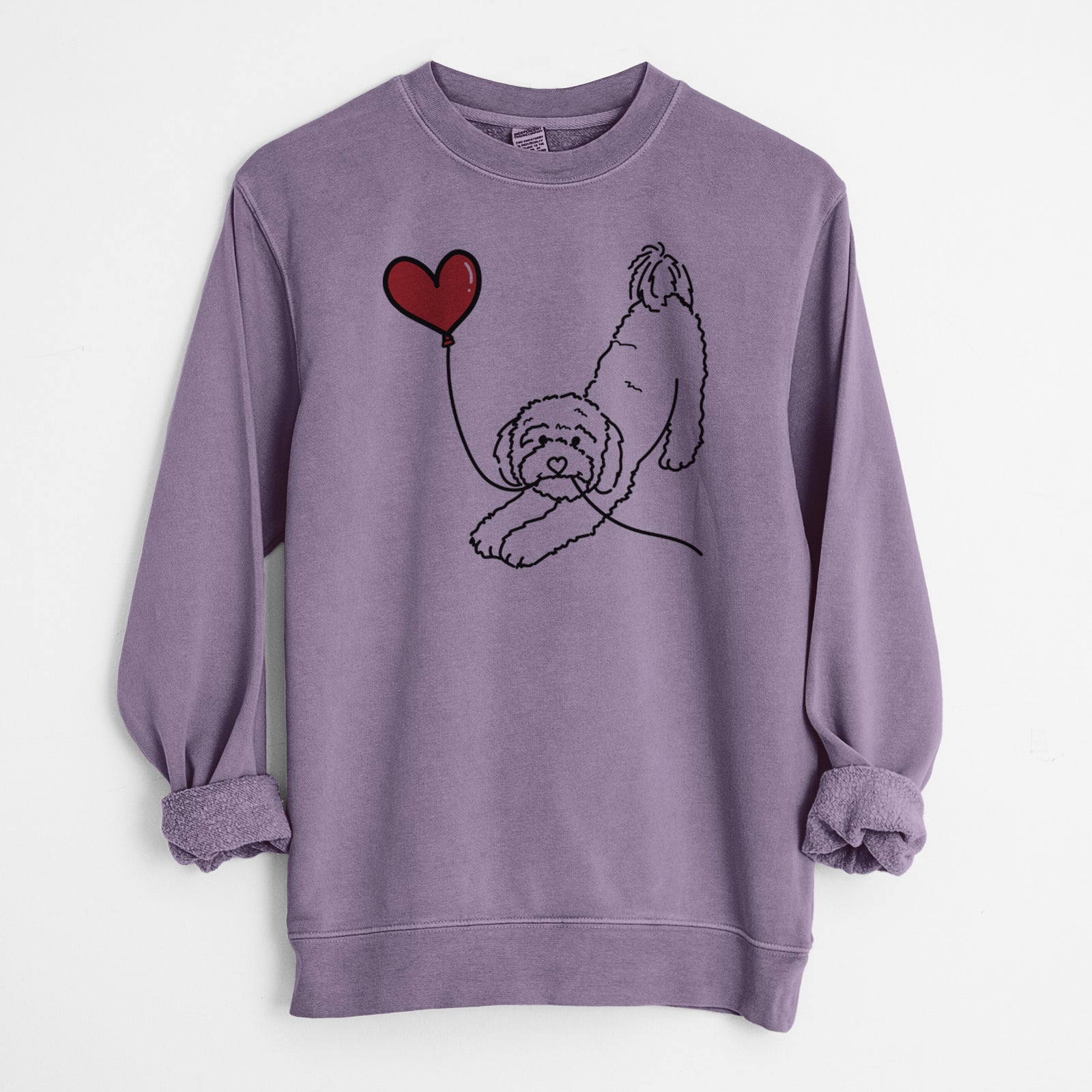 Minimalist line drawing of a Cavapoo Heart String holding a heart balloon on a Plum Unisex pigment dyed crew sweatshirt