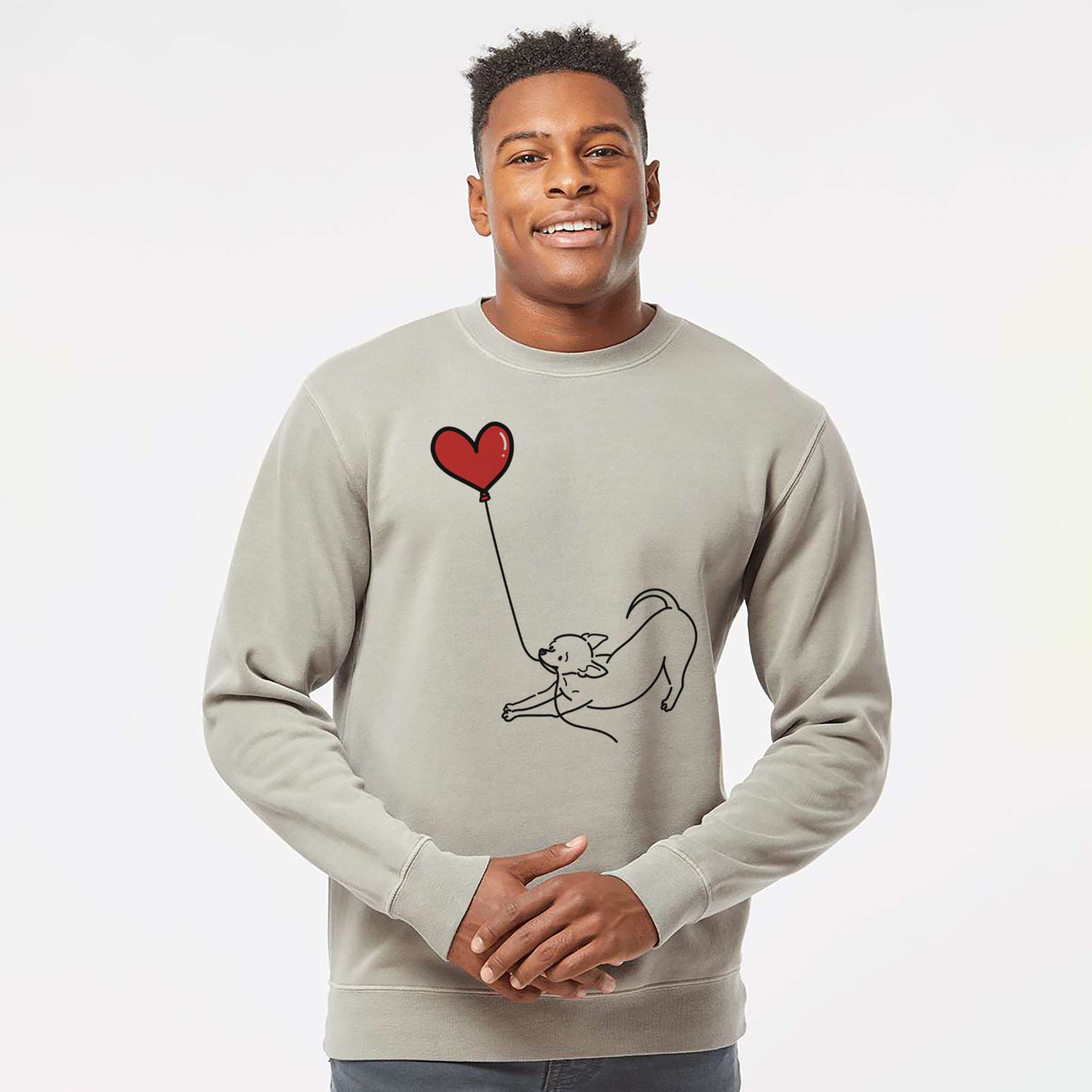 Minimalist line drawing of a Chihuahua Heart String holding a heart balloon on a Cement Unisex pigment dyed crew sweatshirt