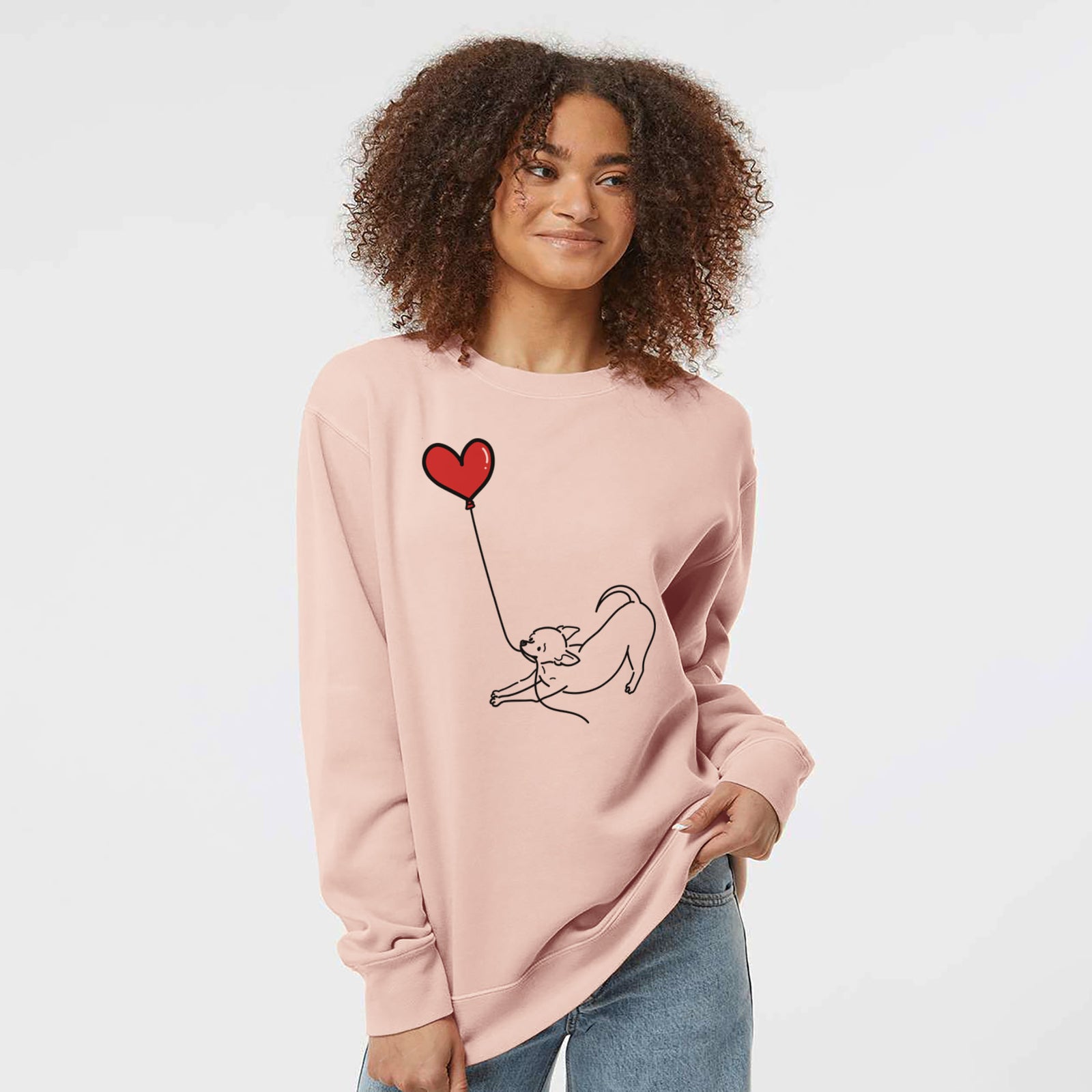 Minimalist line drawing of a Chihuahua Heart String holding a heart balloon on a Dusty Pink Unisex pigment dyed crew sweatshirt