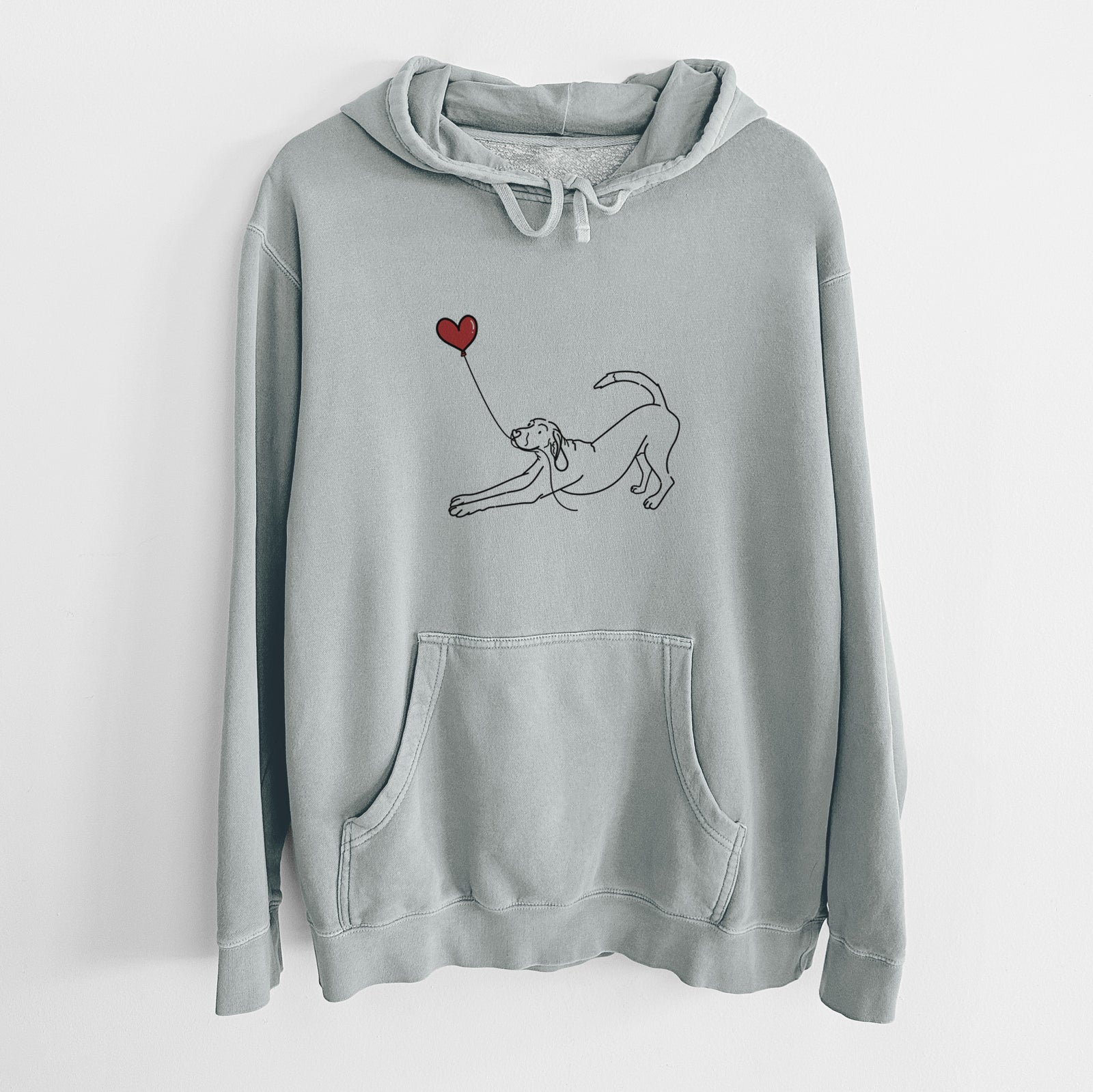 Minimalist line drawing of a Coonhound Heart String holding a heart balloon on a Sage Unisex pigment dyed hoodie