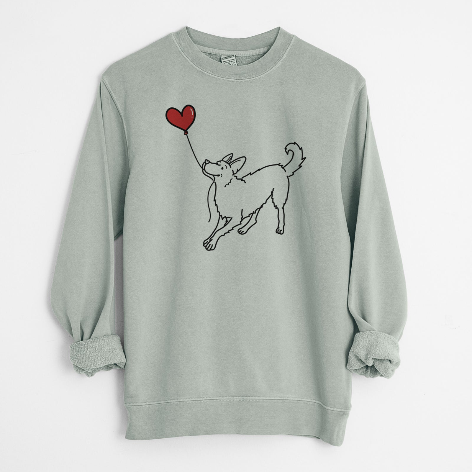Minimalist line drawing of a German Shepherd Heart String holding a heart balloon on a Sage Unisex pigment dyed crew sweatshirt