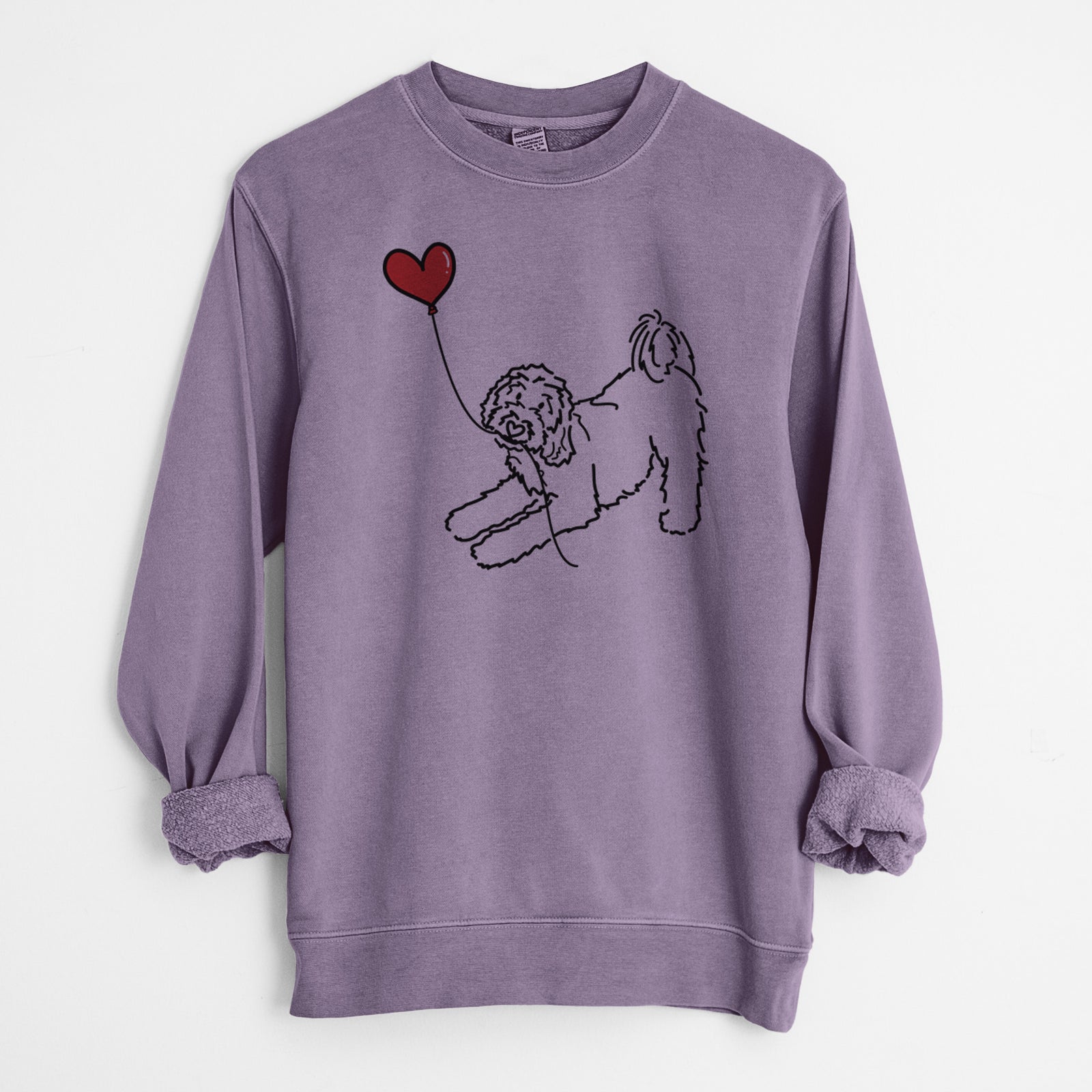 Minimalist line drawing of a Goldendoodle Heart String holding a heart balloon on a Plum Unisex pigment dyed crew sweatshirt