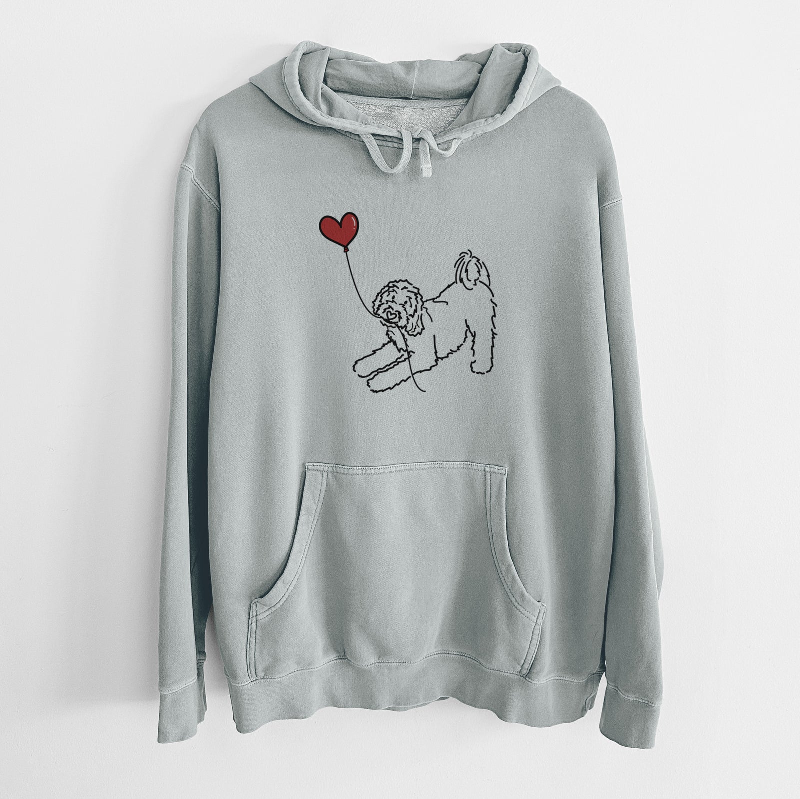Minimalist line drawing of a Goldendoodle Heart String holding a heart balloon on a Sage Unisex pigment dyed hoodie