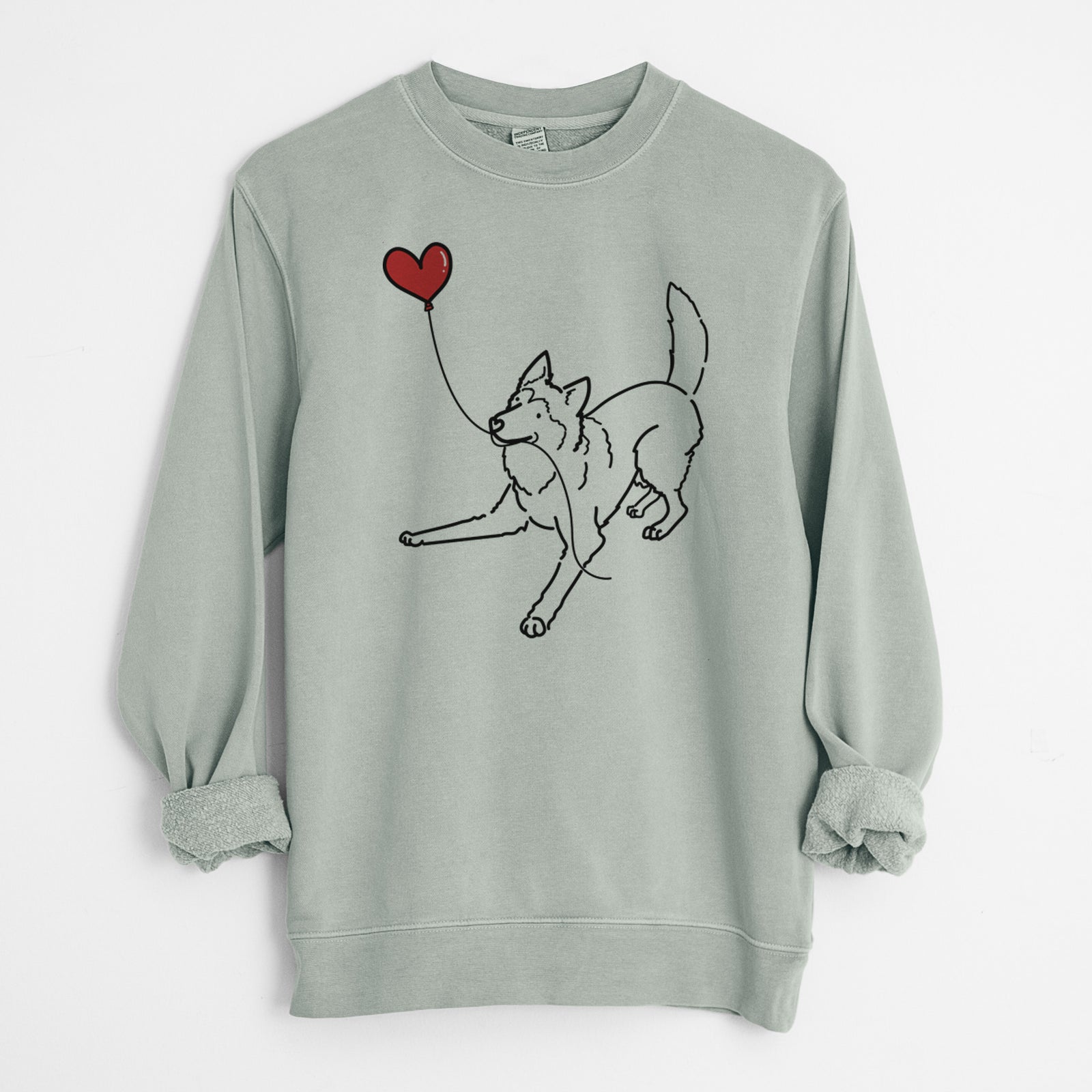 Minimalist line drawing of a Siberian Husky Heart String holding a heart balloon on a Sage Unisex pigment dyed crew sweatshirt