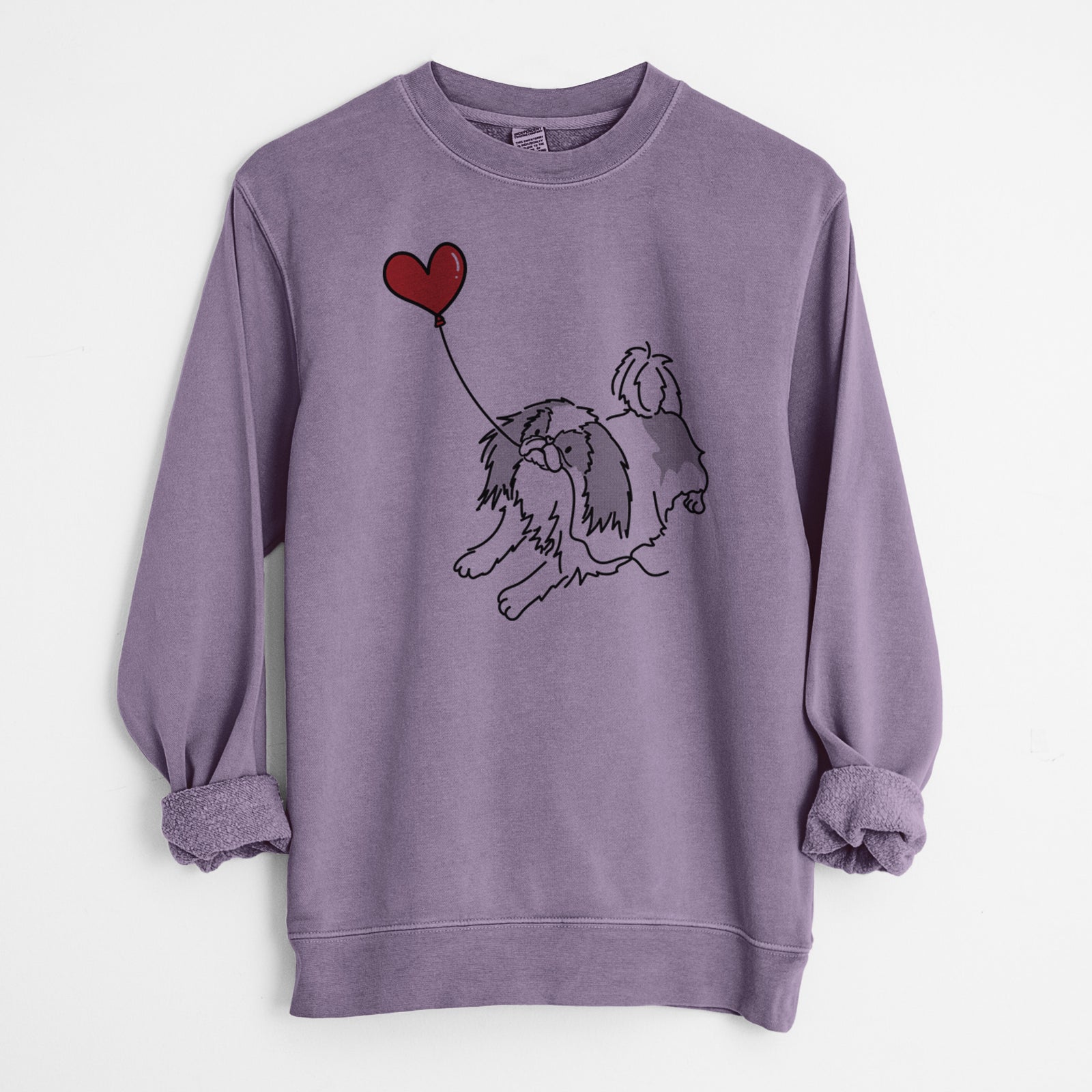 Minimalist line drawing of a Japanese Chin Heart String holding a heart balloon on a Plum Unisex pigment dyed crew sweatshirt