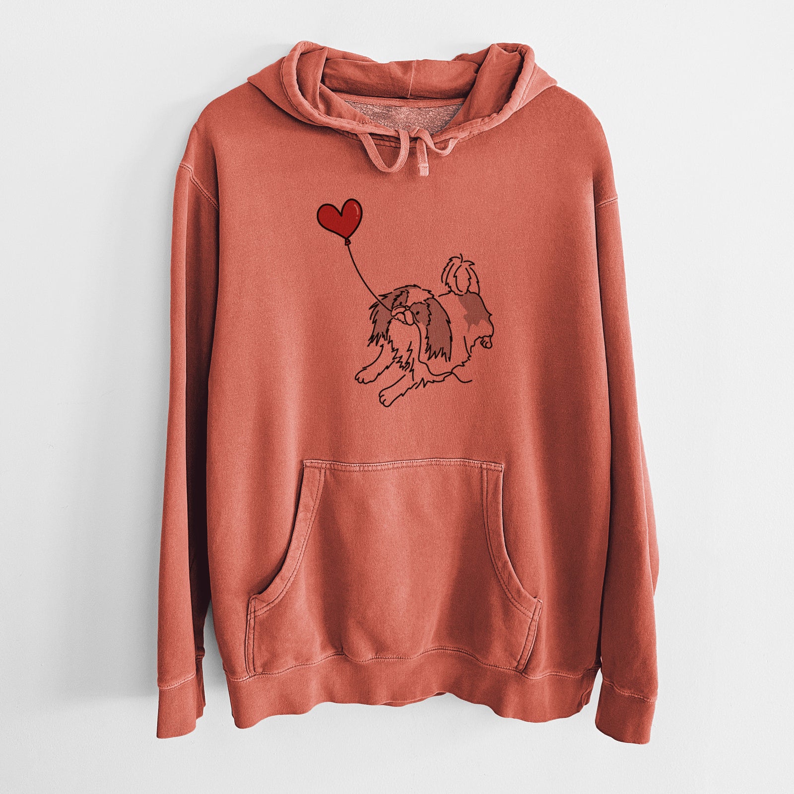 Minimalist line drawing of a Japanese Chin Heart String holding a heart balloon on an Amber Unisex pigment dyed hoodie