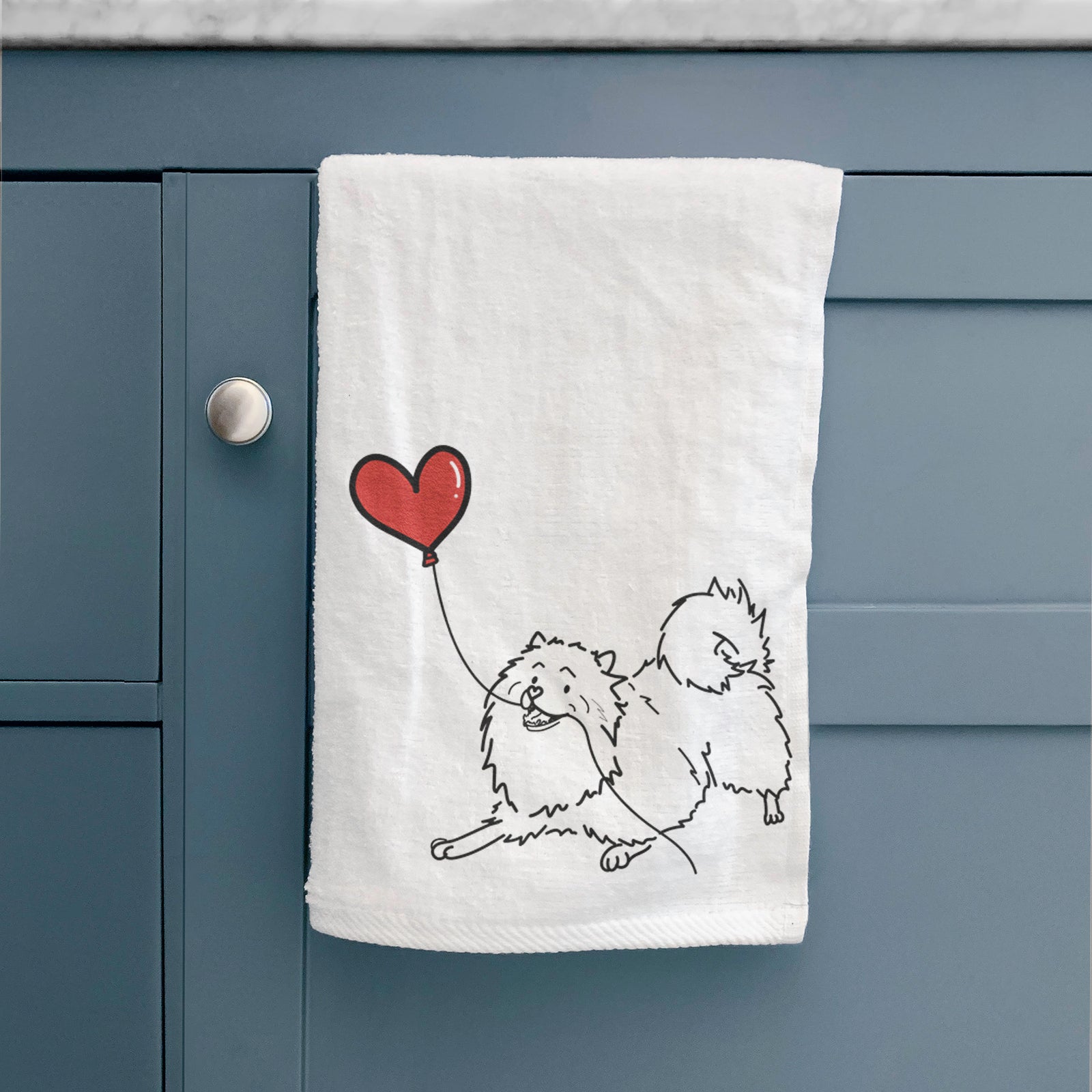Minimalist line drawing of a Keeshond Heart String holding a heart balloon on a decorative hand towel