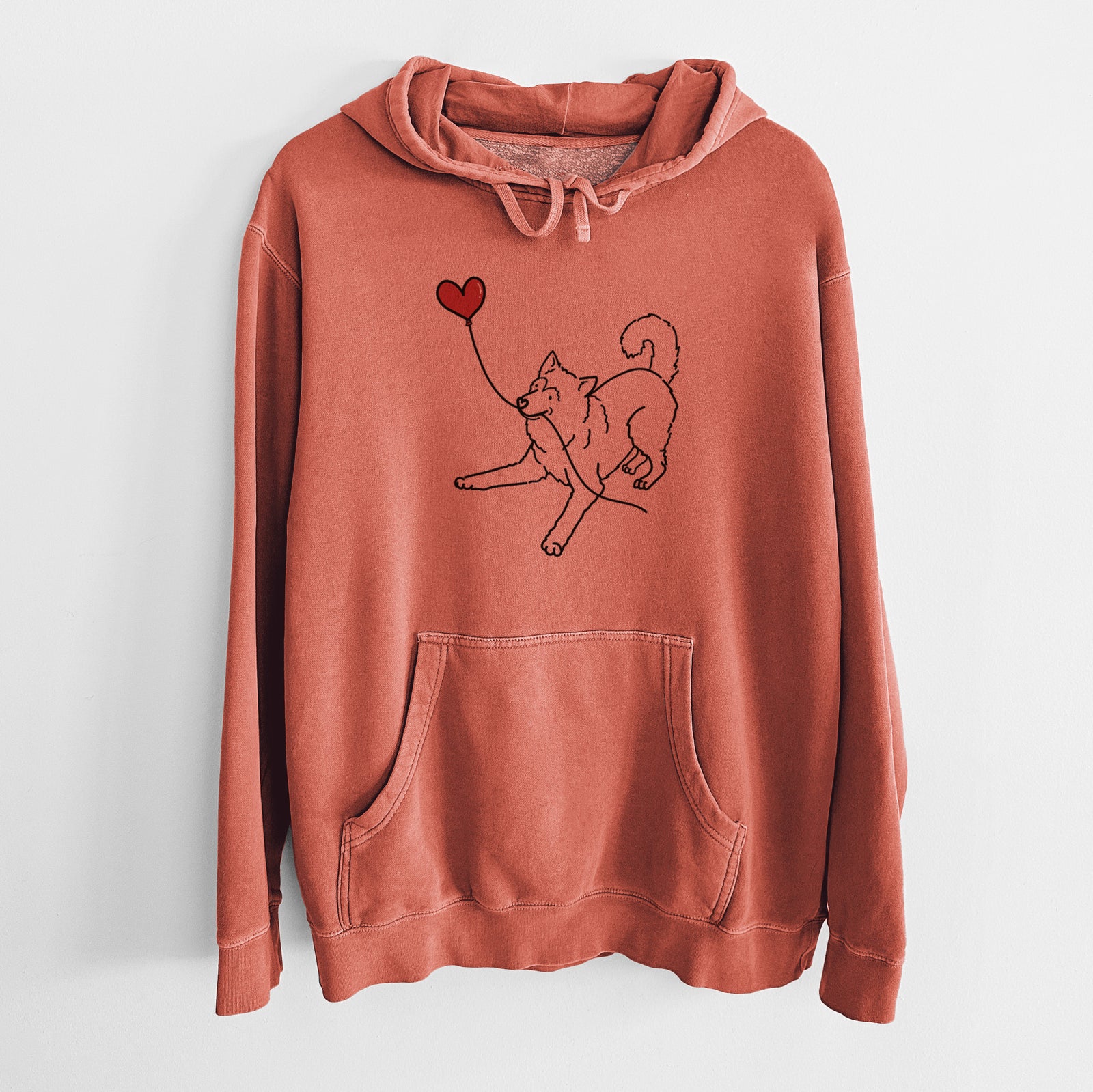 Minimalist line drawing of an Alaskan Malamute Heart String holding a heart balloon on an Amber Unisex pigment dyed hoodie