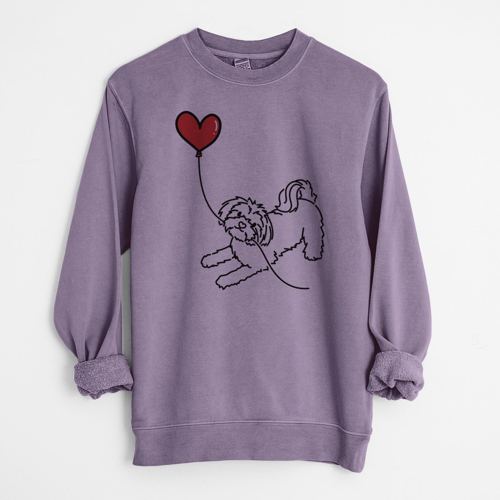 Minimalist line drawing of a Maltese Heart String holding a heart balloon on a Plum Unisex pigment dyed crew sweatshirt
