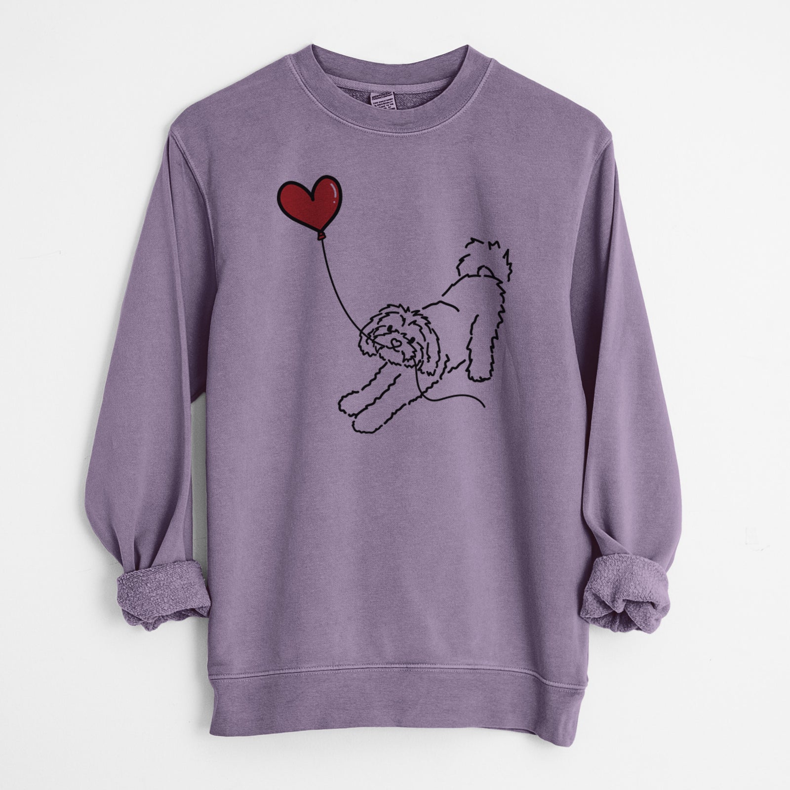 Minimalist line drawing of a Maltipoo Heart String holding a heart balloon on a Plum Unisex pigment dyed crew sweatshirt