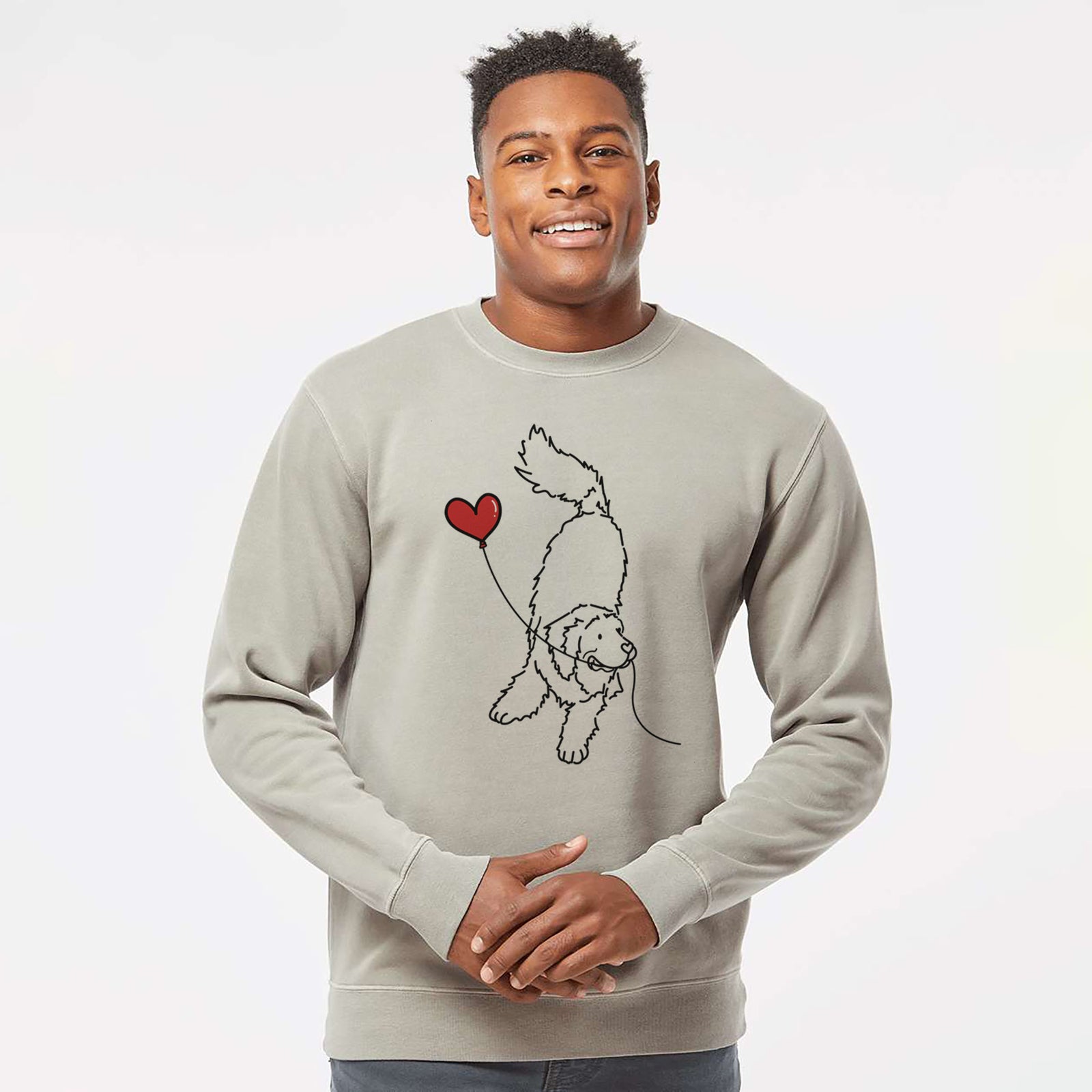 Minimalist line drawing of a Newfoundland Heart String holding a heart balloon on a Cement Unisex pigment dyed crew sweatshirt