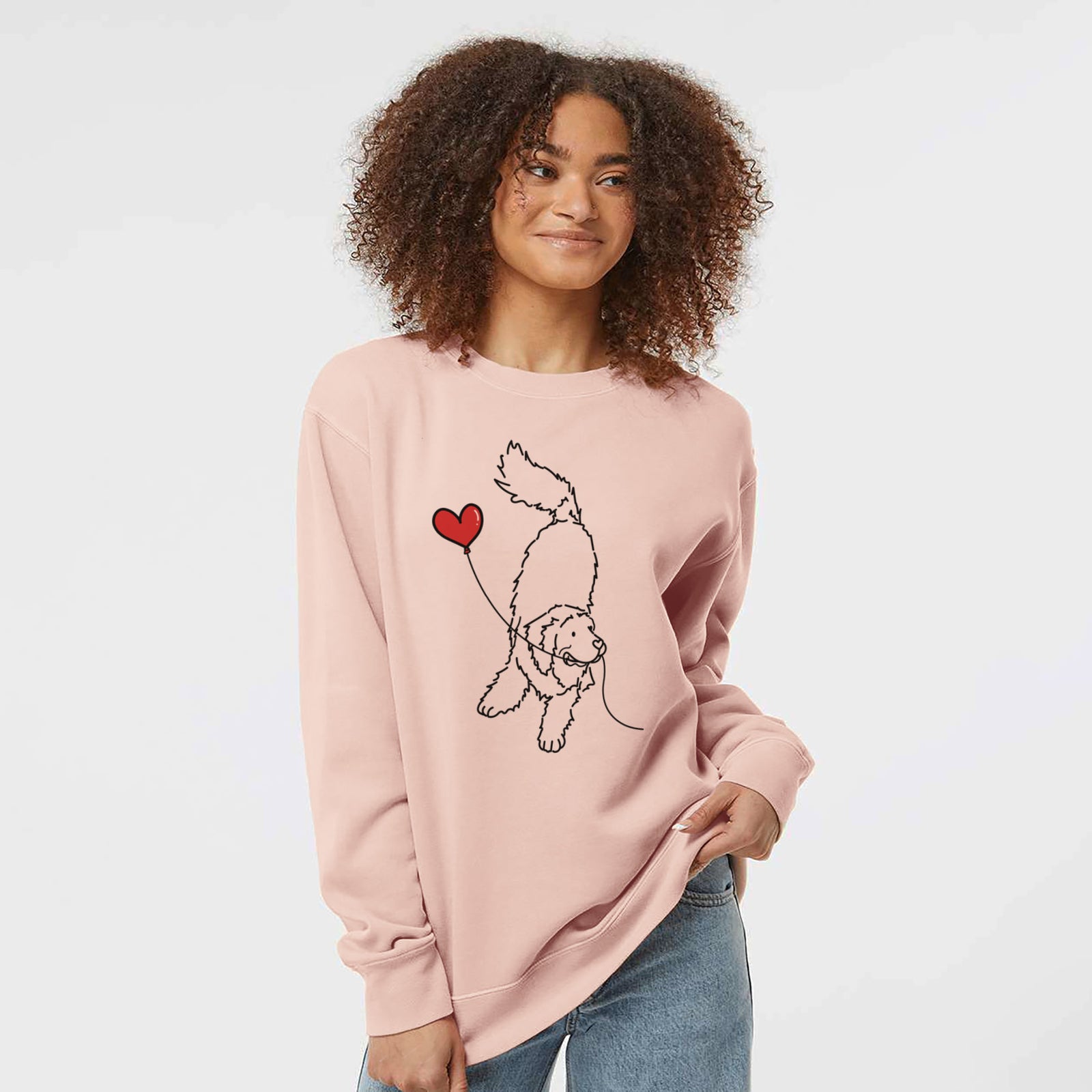 Minimalist line drawing of a Newfoundland Heart String holding a heart balloon on a Dusty Pink Unisex pigment dyed crew sweatshirt
