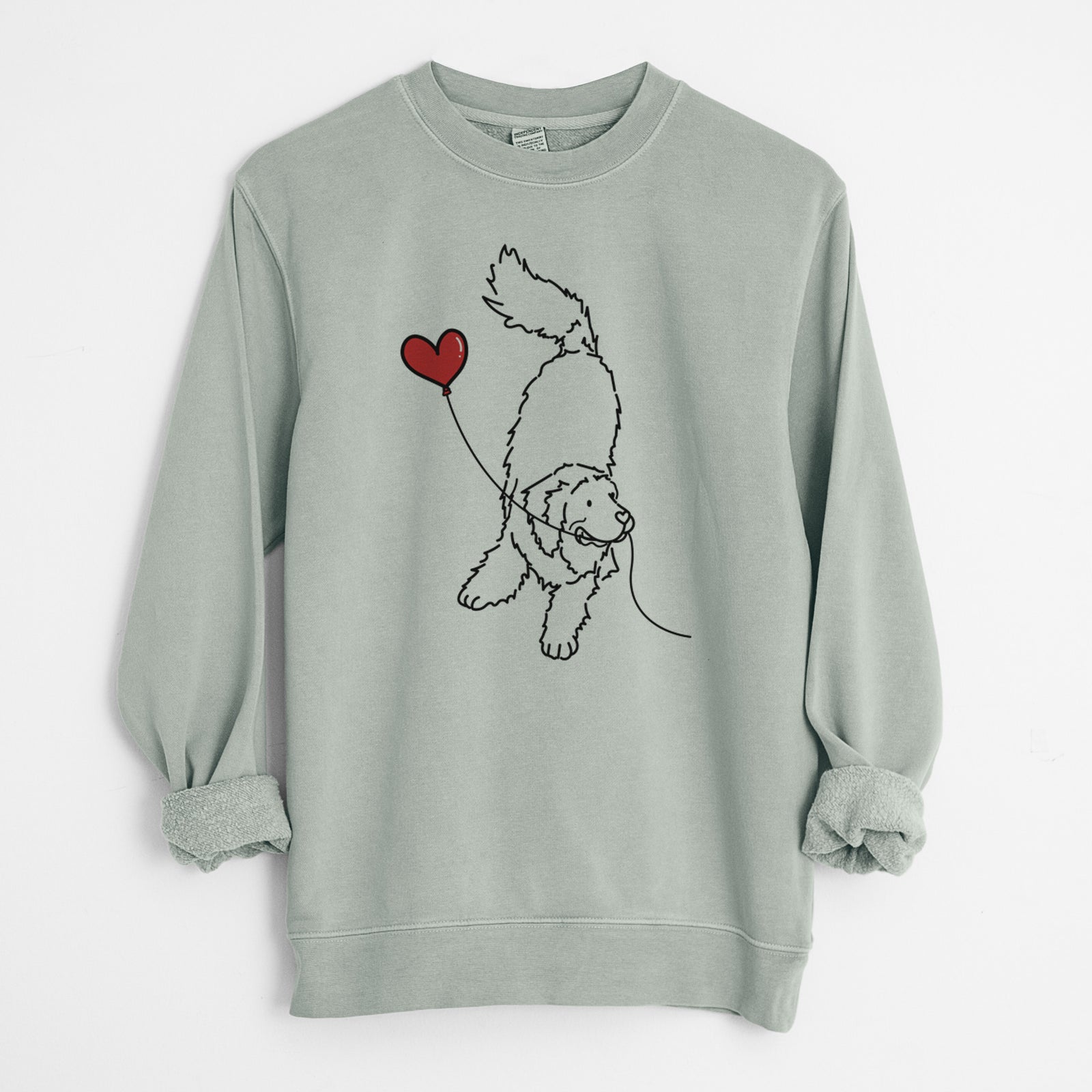 Minimalist line drawing of a Newfoundland Heart String holding a heart balloon on a Sage Unisex pigment dyed crew sweatshirt