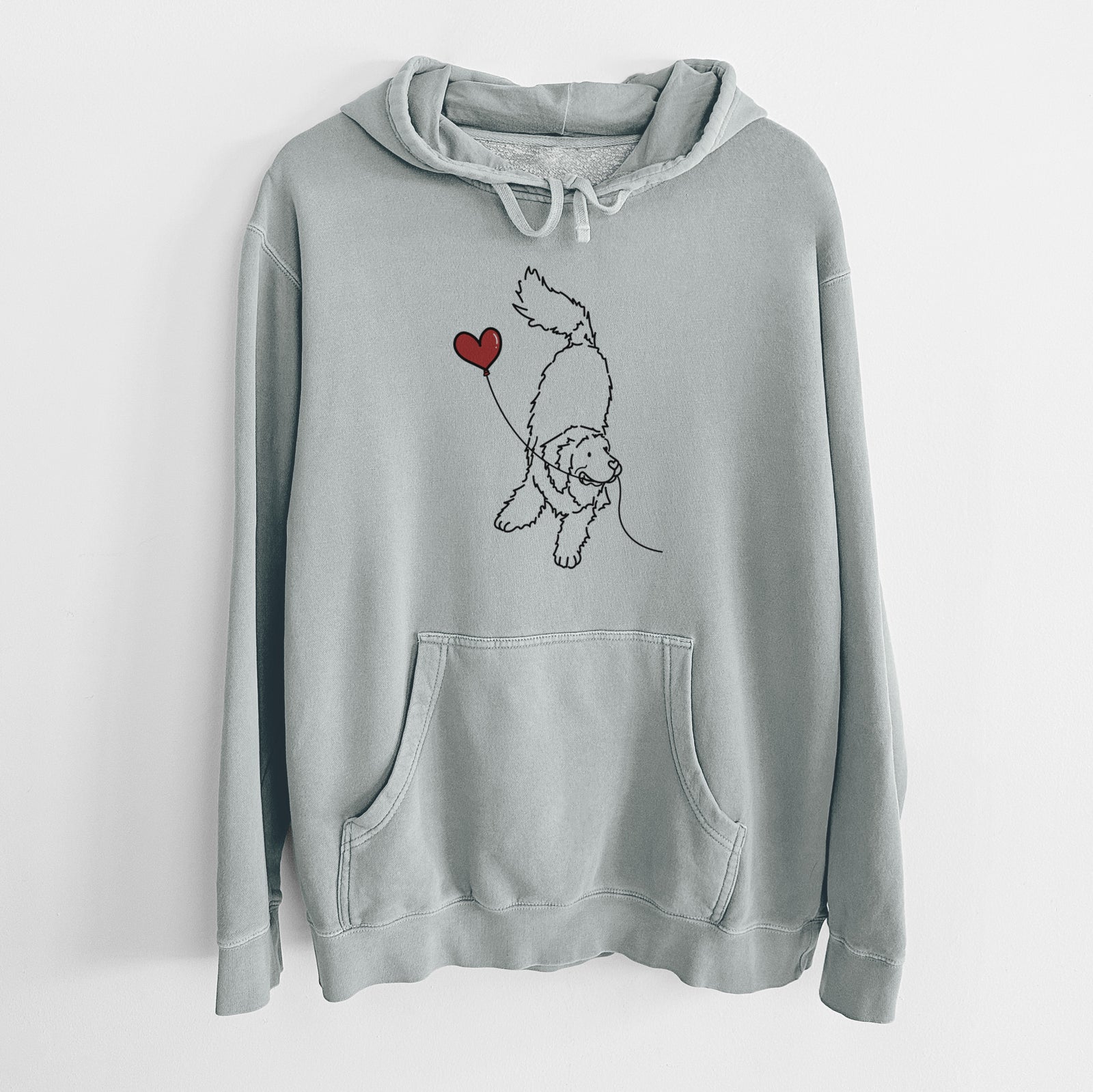 Minimalist line drawing of a Newfoundland Heart String holding a heart balloon on a Sage Unisex pigment dyed hoodie
