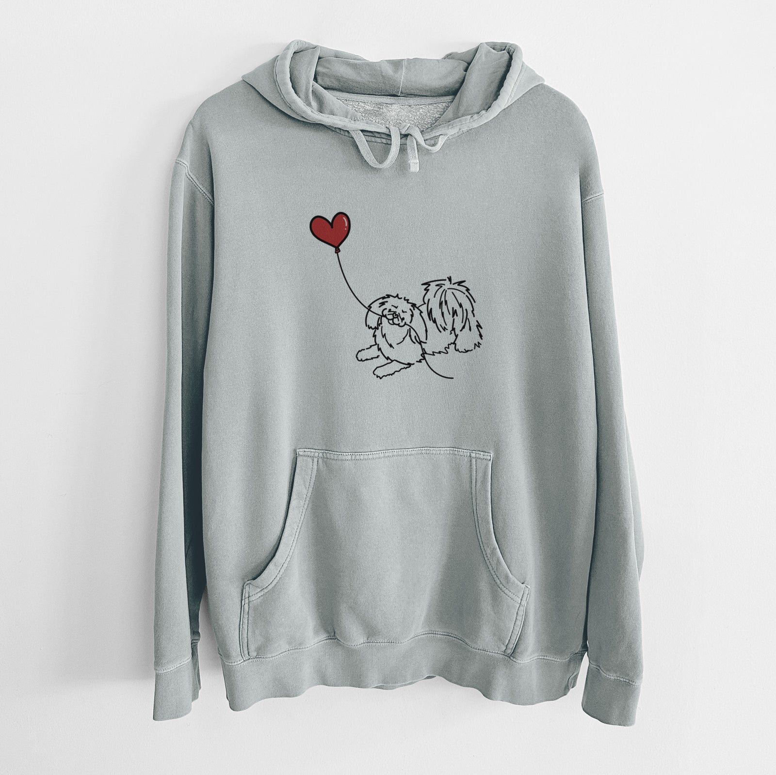 Minimalist line drawing of a Pekingese Heart String holding a heart balloon on a Sage Unisex pigment dyed hoodie