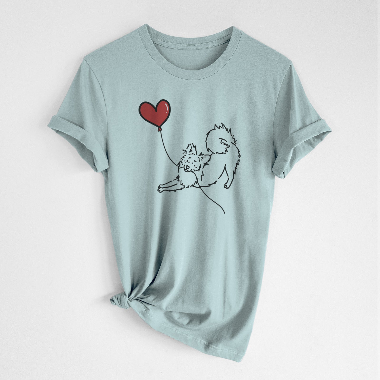 Minimalist line drawing of a Pomchi Heart String- Unisex Crewneck holding a heart balloon on a Dusty Blue Unisex crewneck, worn by a woman