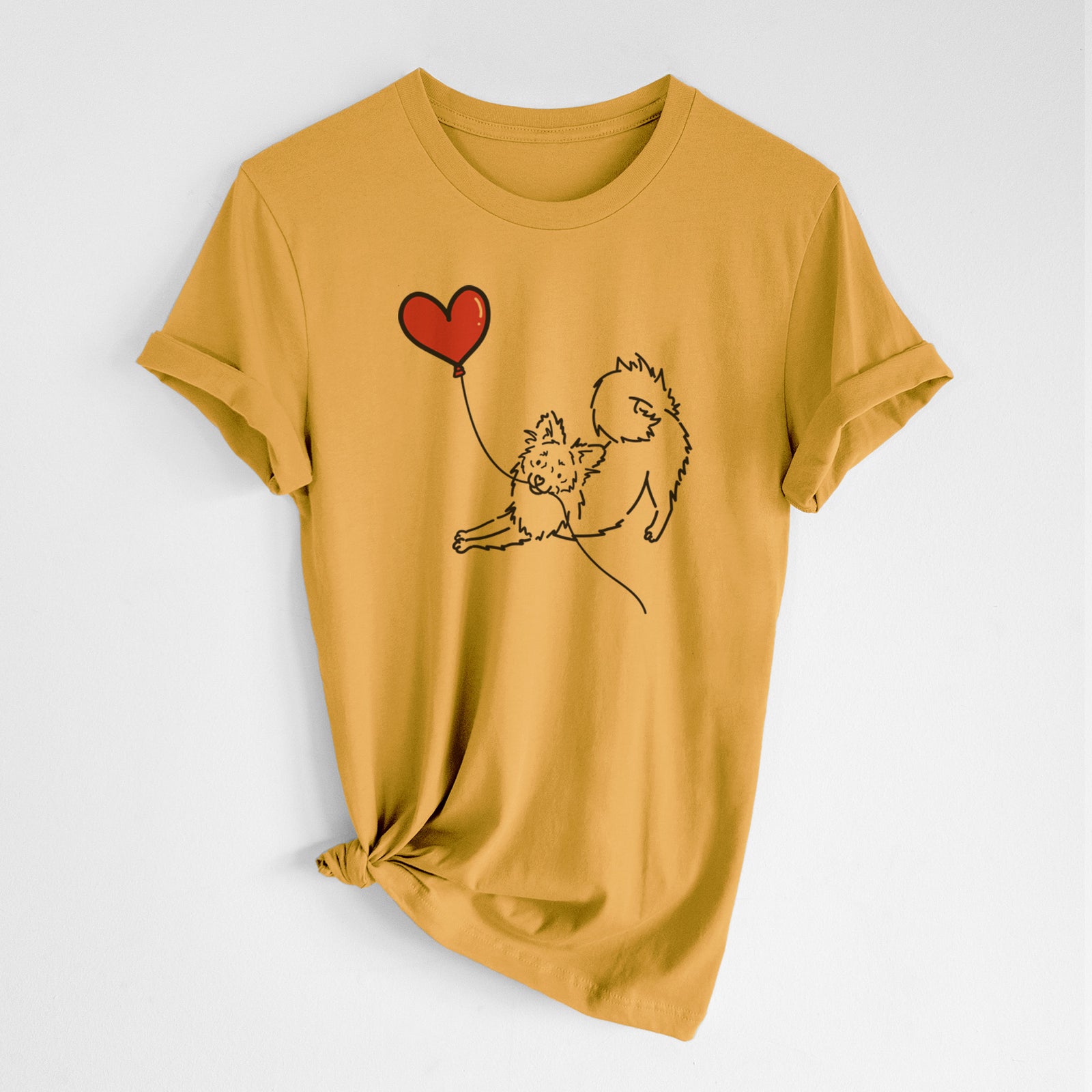 Minimalist line drawing of a Pomchi Heart String- Unisex Crewneck holding a heart balloon on a Mustard Unisex crewneck, worn by a woman