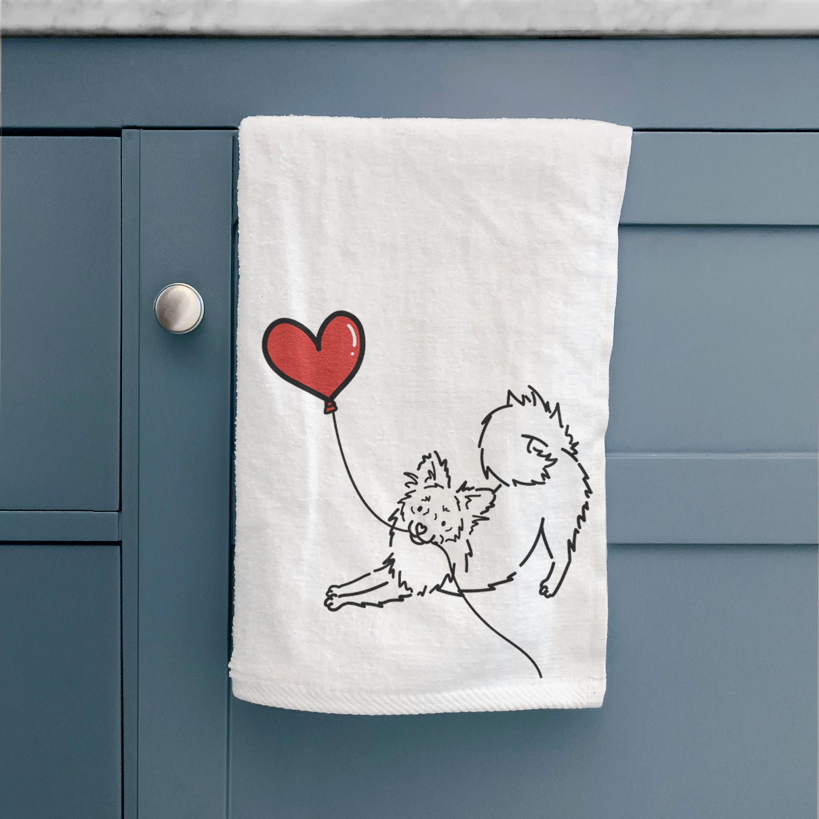 Minimalist line drawing of a Pomchi Heart String holding a heart balloon on a hand towel