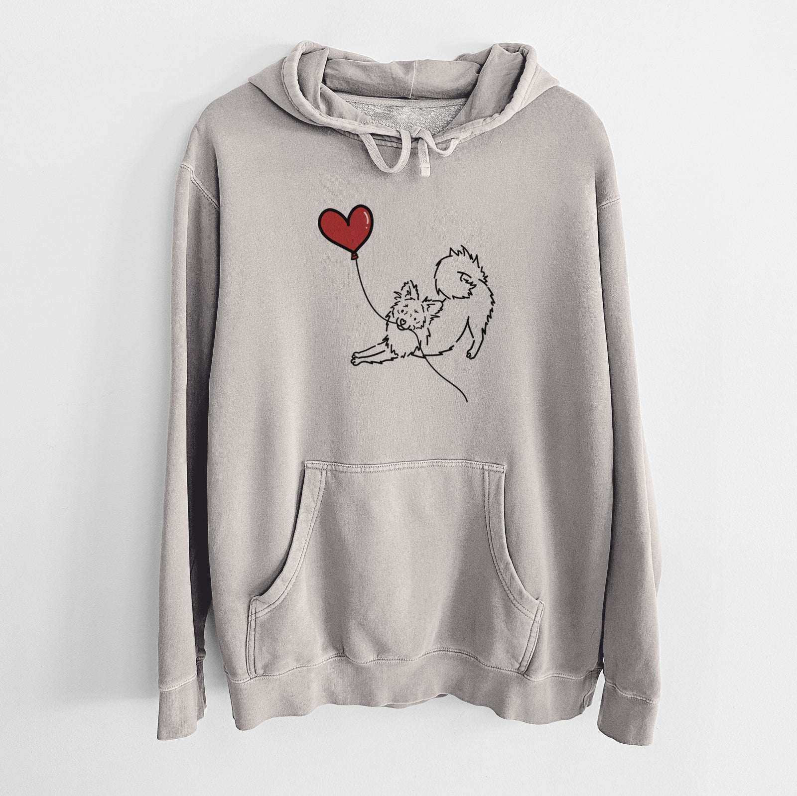 Minimalist line drawing of a Pomchi Heart String holding a heart balloon on a Cement Unisex pigment dyed hoodie