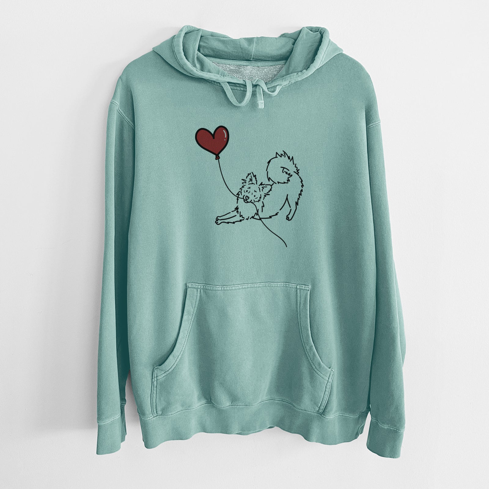Minimalist line drawing of a Pomchi Heart String holding a heart balloon on a Mint Unisex pigment dyed hoodie