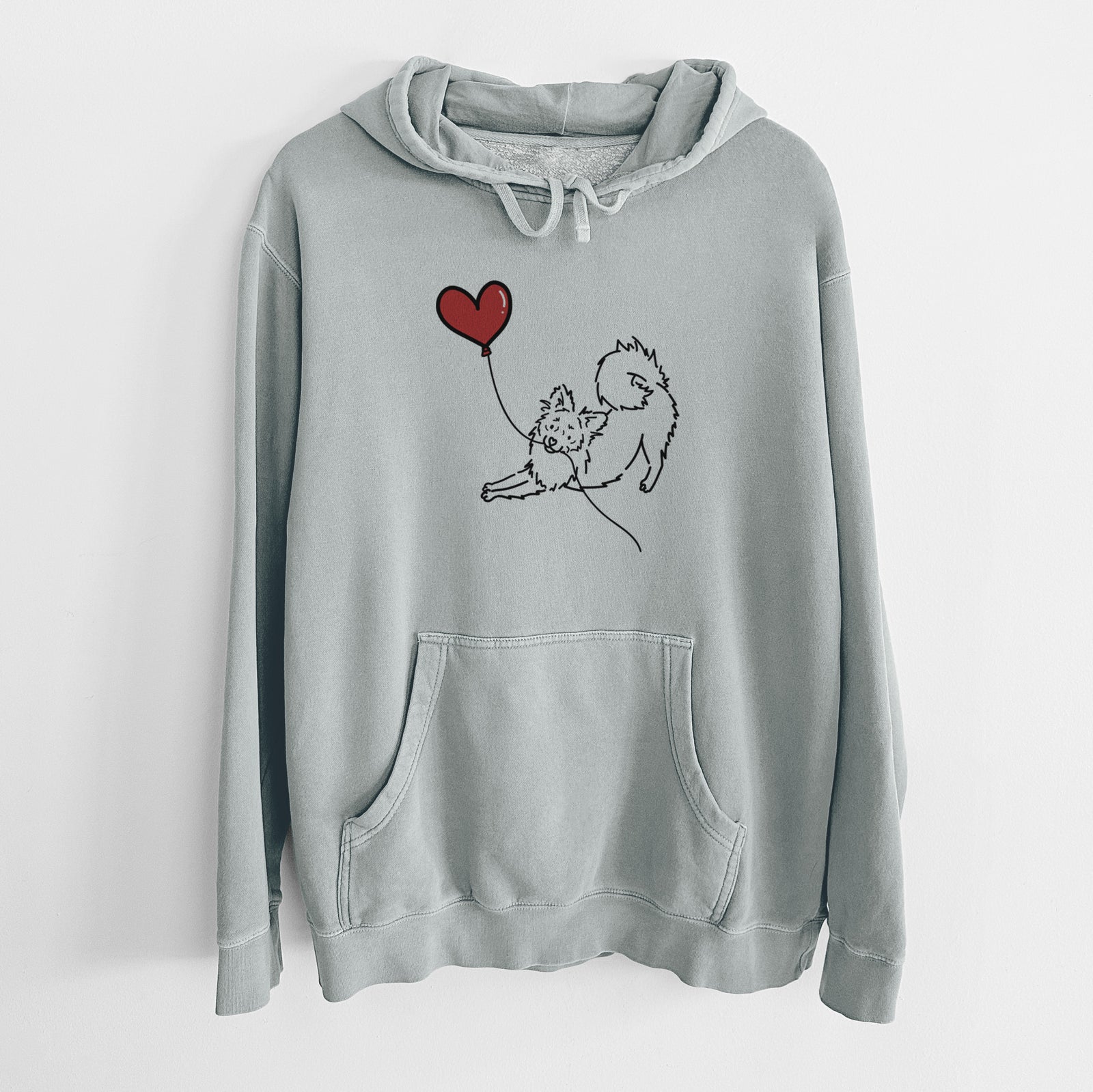 Minimalist line drawing of a Pomchi Heart String holding a heart balloon on a Sage Unisex pigment dyed hoodie