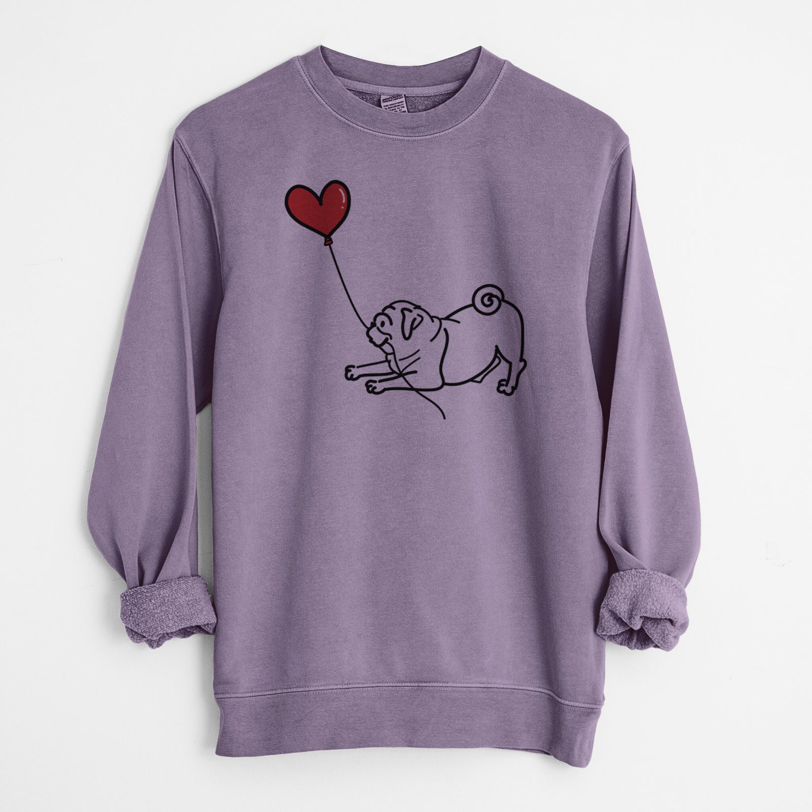 Minimalist line drawing of a Pug Heart String holding a heart balloon on a Plum Unisex pigment dyed crew sweatshirt