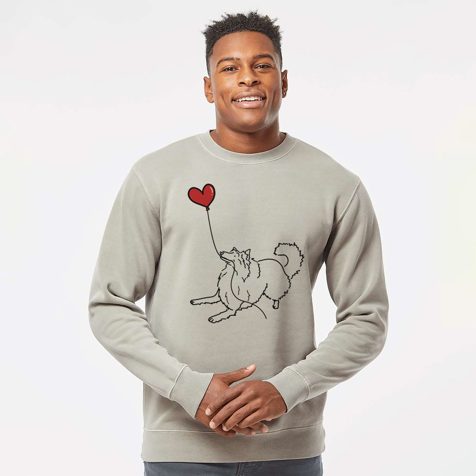 Minimalist line drawing of a Rough Collie Heart String holding a heart balloon on a Cement Unisex pigment dyed crew sweatshirt