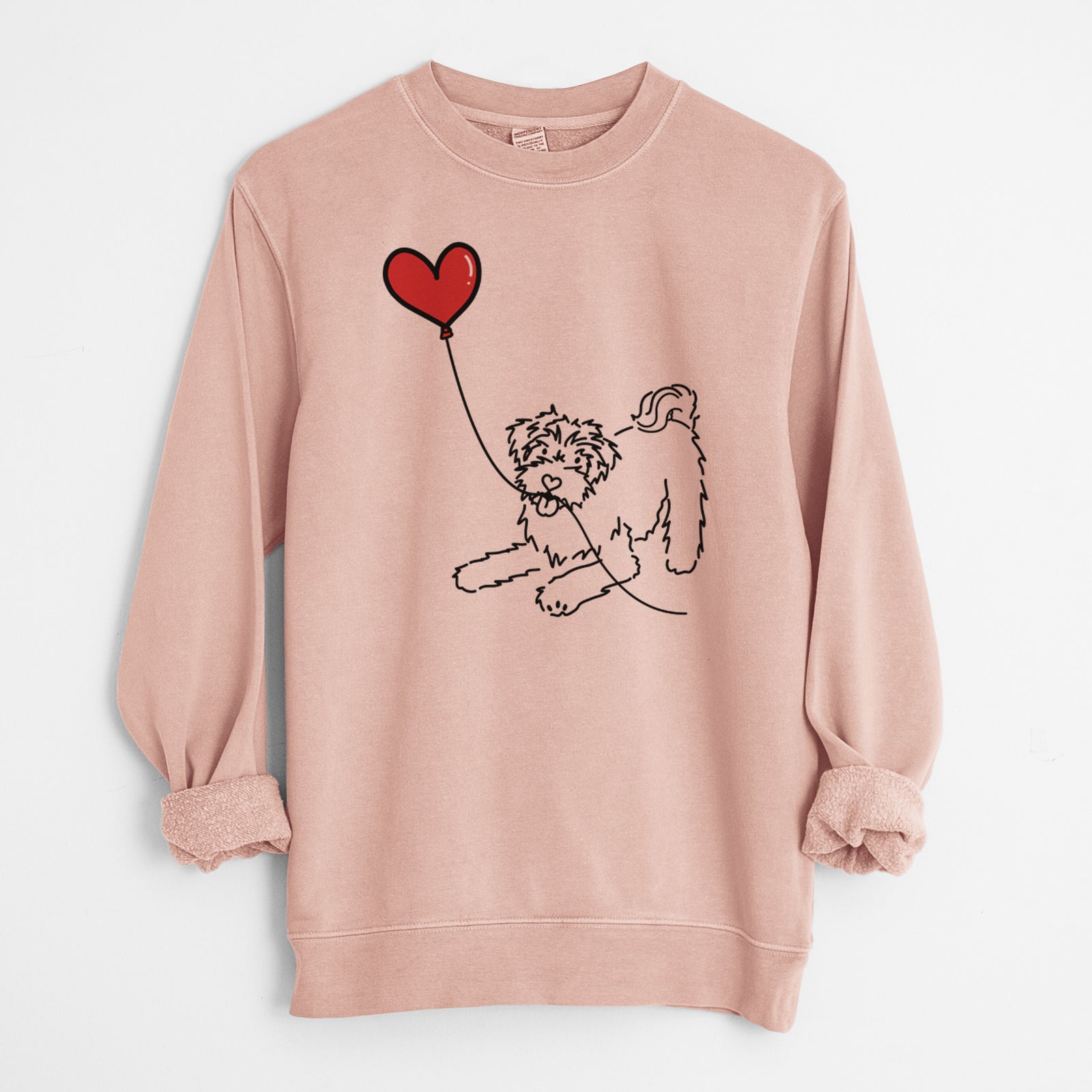 Minimalist line drawing of a Schnoodle Heart String holding a heart balloon on a Dusty Pink Unisex pigment dyed crew sweatshirt