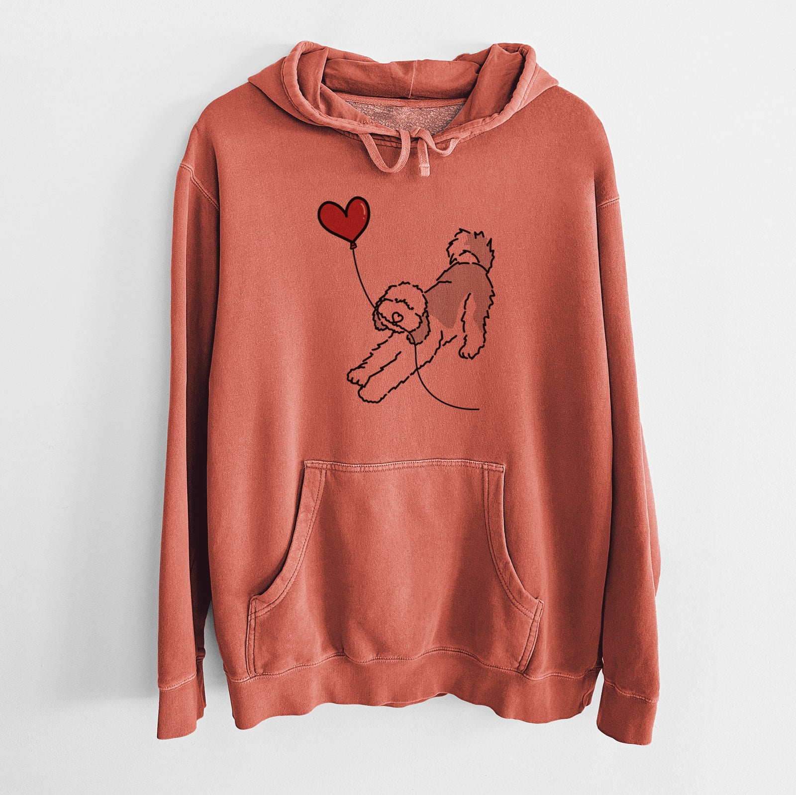 Minimalist line drawing of a Sheepadoodle Heart String holding a heart balloon on an Amber Unisex pigment dyed hoodie