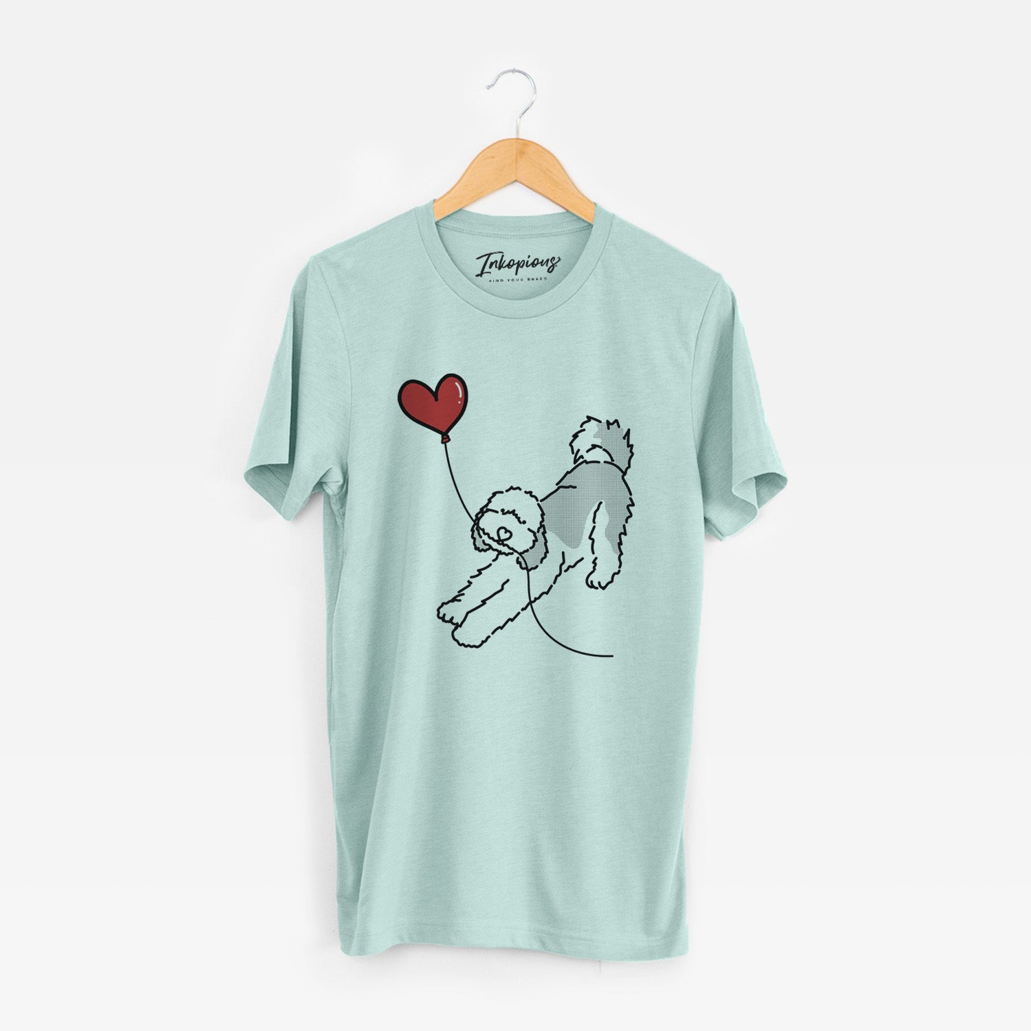 Minimalist line drawing of a Sheepadoodle Heart String holding a heart balloon on a Heather Sage Unisex crewneck