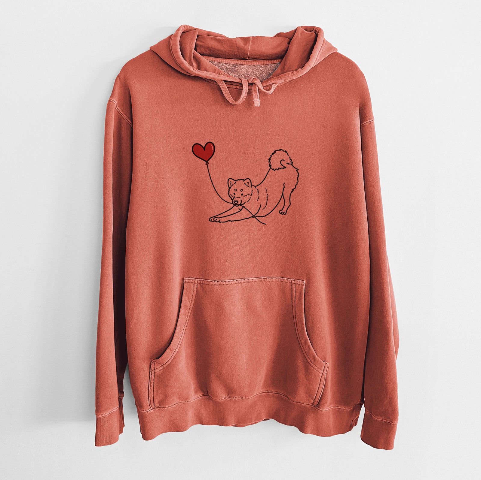 Minimalist line drawing of a Shiba Inu Heart String holding a heart balloon on an Amber Unisex pigment dyed hoodie