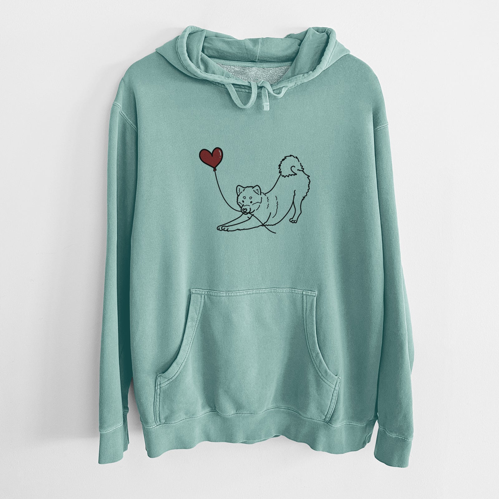 Minimalist line drawing of a Shiba Inu Heart String holding a heart balloon on a Mint Unisex pigment dyed hoodie