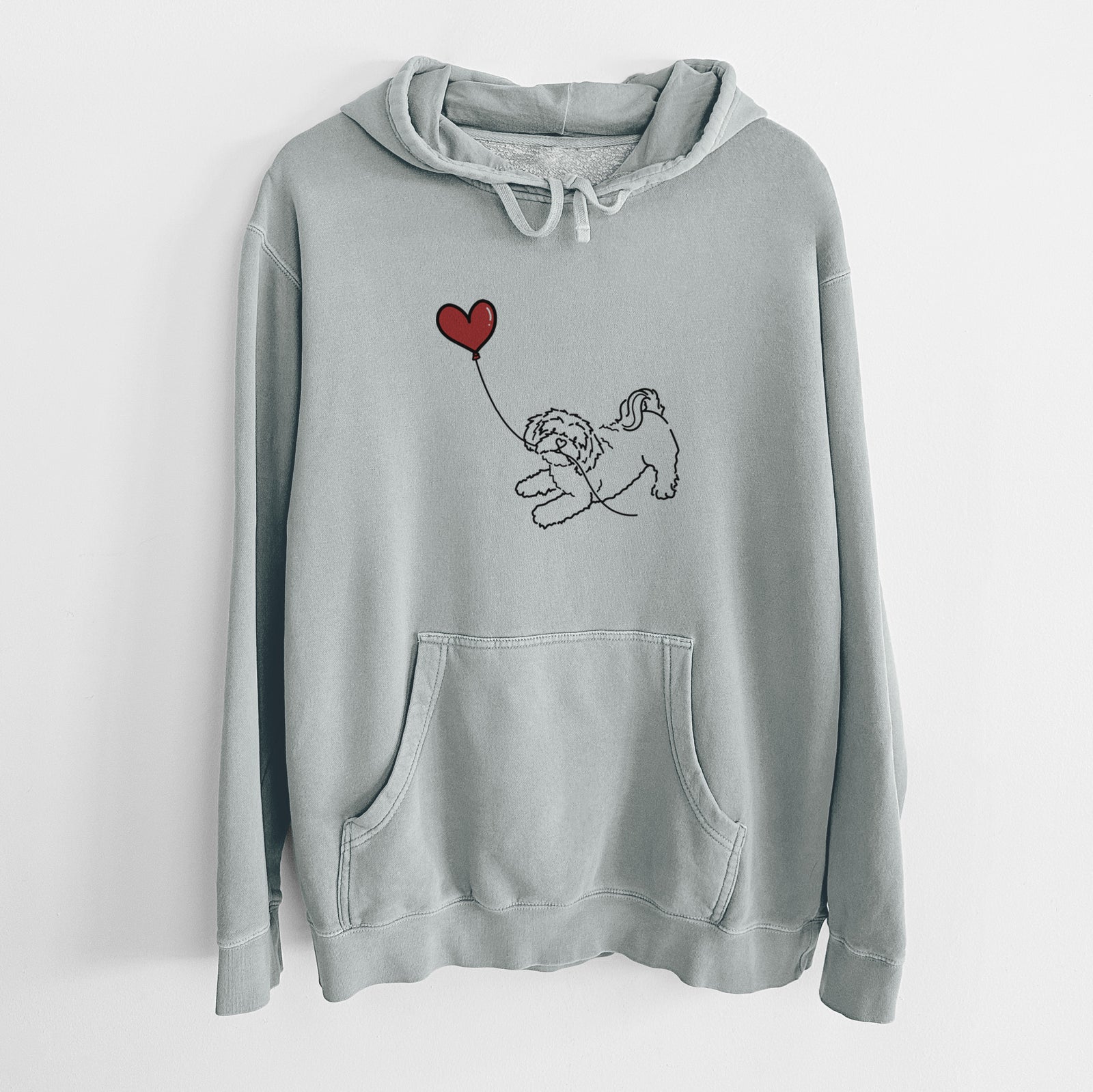 Minimalist line drawing of a Shihpoo Heart String holding a heart balloon on a Sage Unisex pigment dyed hoodie