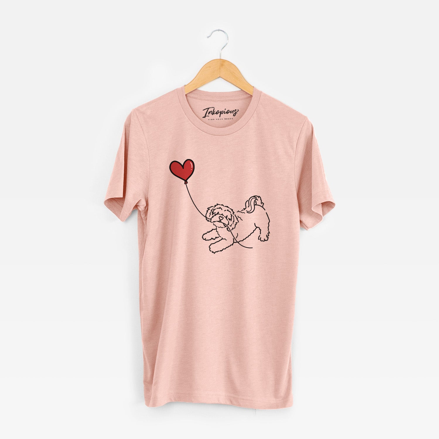 Minimalist line drawing of a Shihpoo Heart String holding a heart balloon on a Peach Unisex crewneck