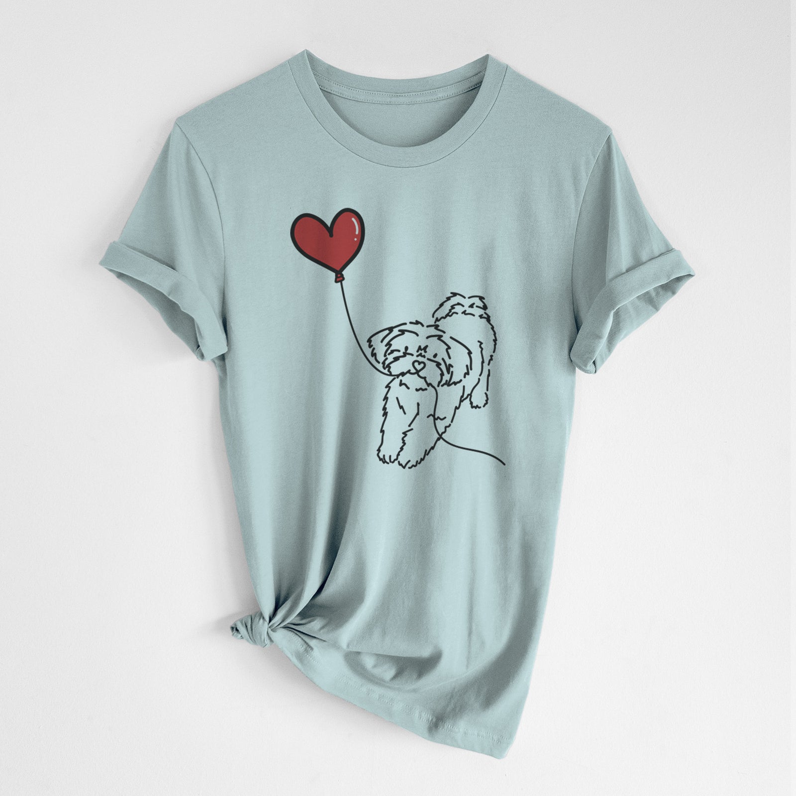 Minimalist line drawing of a Shorkie Heart String- Unisex Crewneck holding a heart balloon on a Dusty Blue Unisex crewneck, worn by a woman